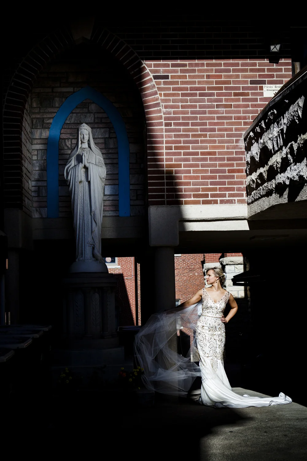 Janna - Jefferson City, MO - Katie set up & took this shot, I was on the walkway to the top right holding a reflector on the Mary statue. I love the composition of Janna and Mary diagonal and the dark shadows and bright contrast. We were running out of time when we took this one, about to head into the Church to start the ceremony. Janna was a sport, willing to take the time to do whatever we thought would look good.
