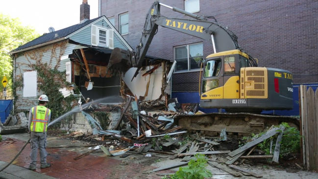 Excavator demolishing a tear-down house in Chicago.