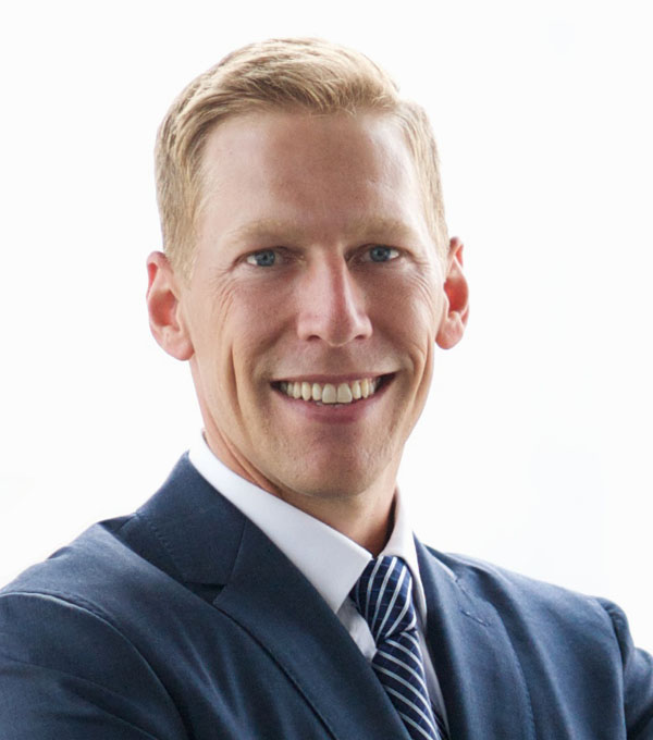 head shot of man wearing blue suit