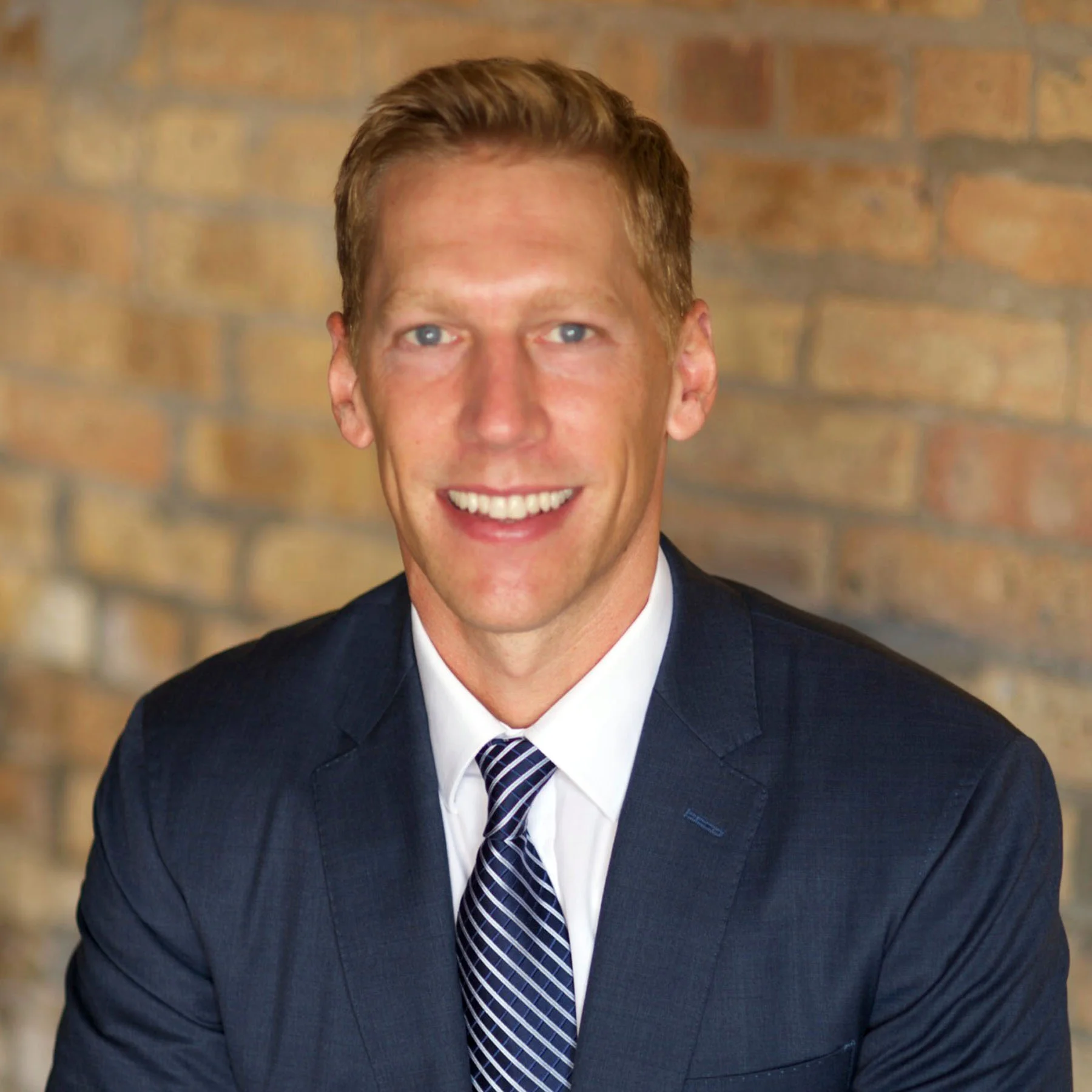 chicago real estate agent wearing blue suit and tie.