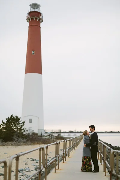 Shannon + Anthony cuddling close for their engagement session by the Barnegat Lighthouse on Long Beach Island