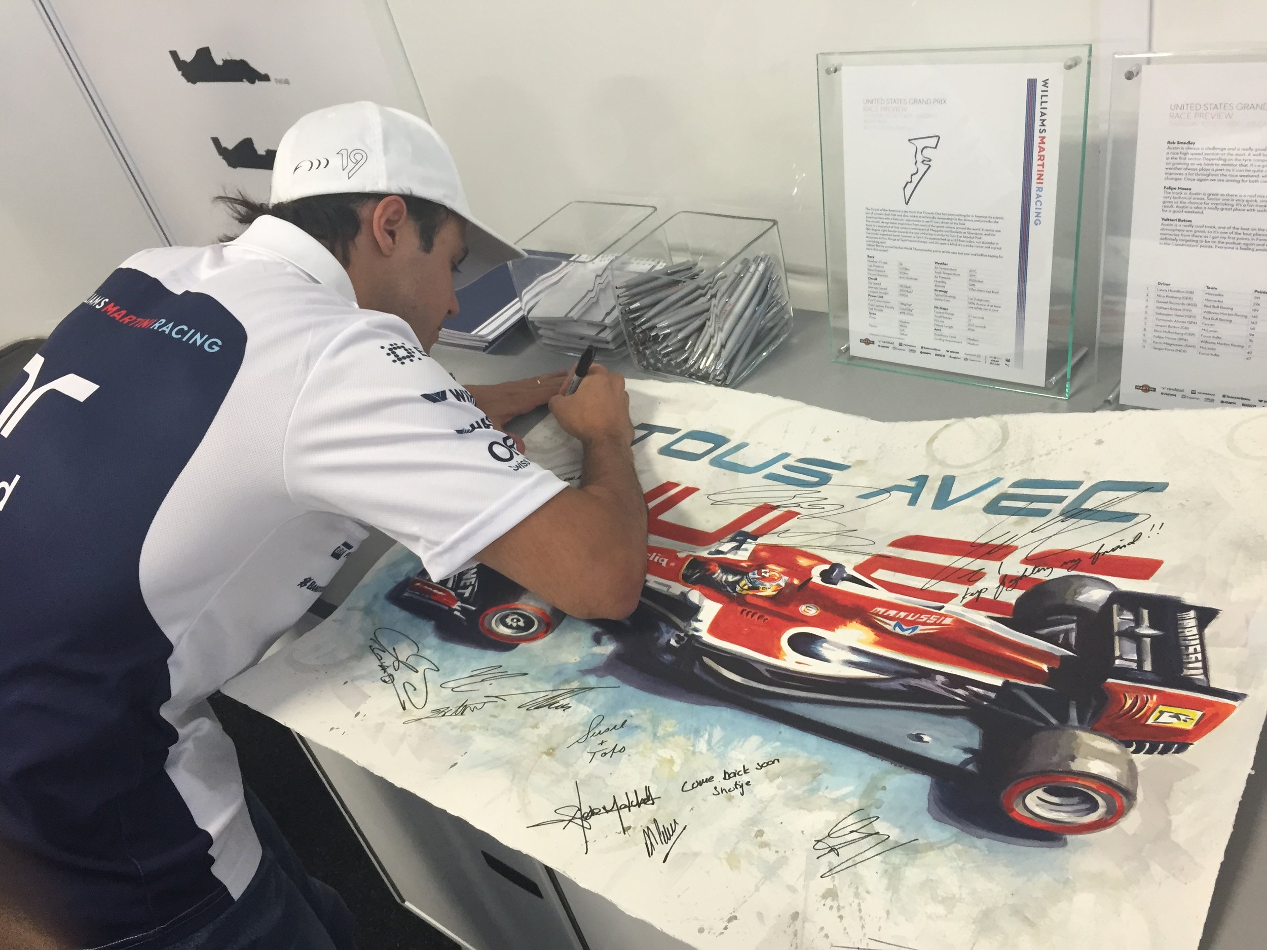  Felipe Massa signing a tribute painting 'With You' of Jules Bianchi at the USGP 