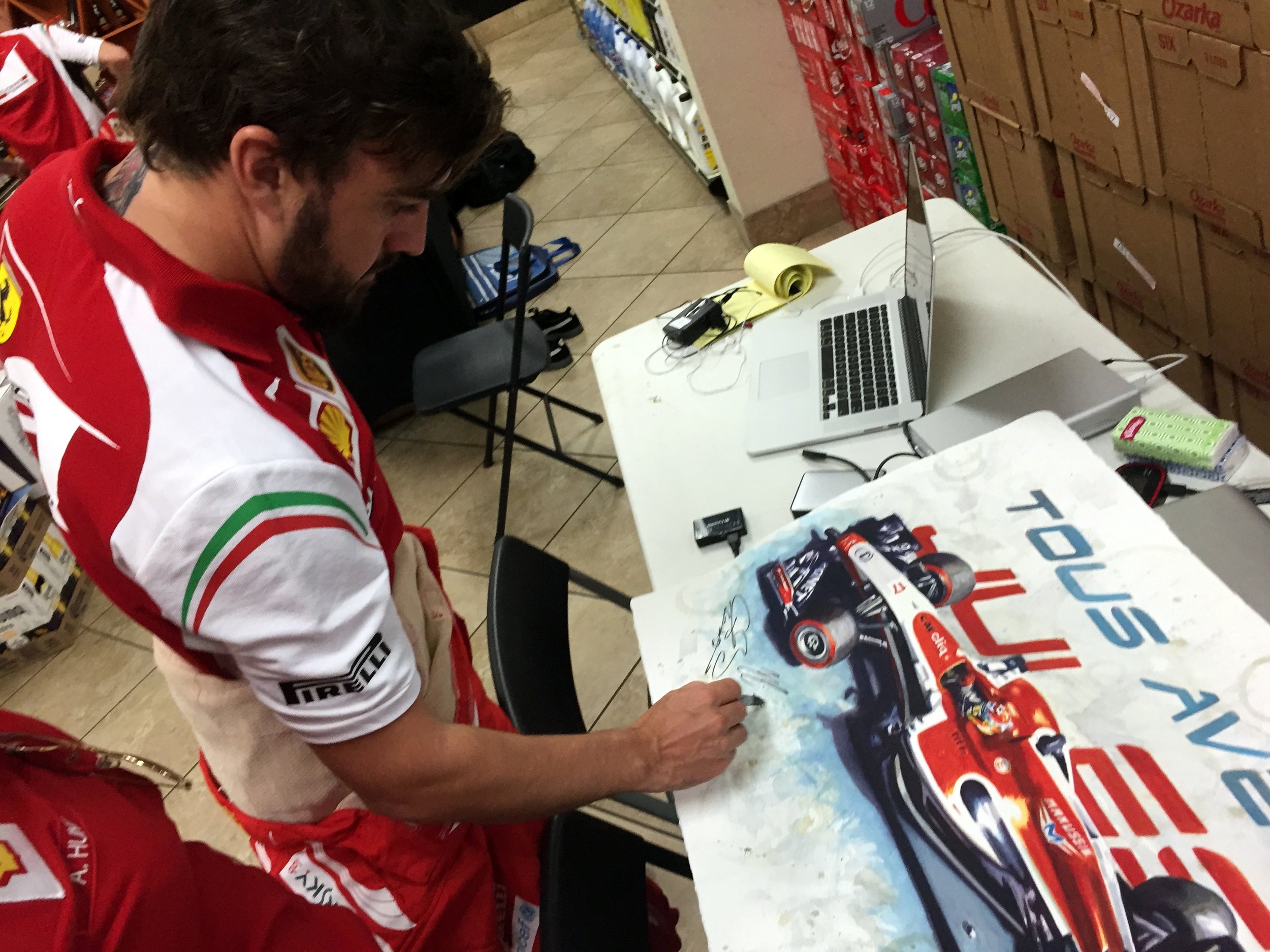  Fernando Alonso signing a tribute painting 'With You' of Jules Bianchi at the USGP 