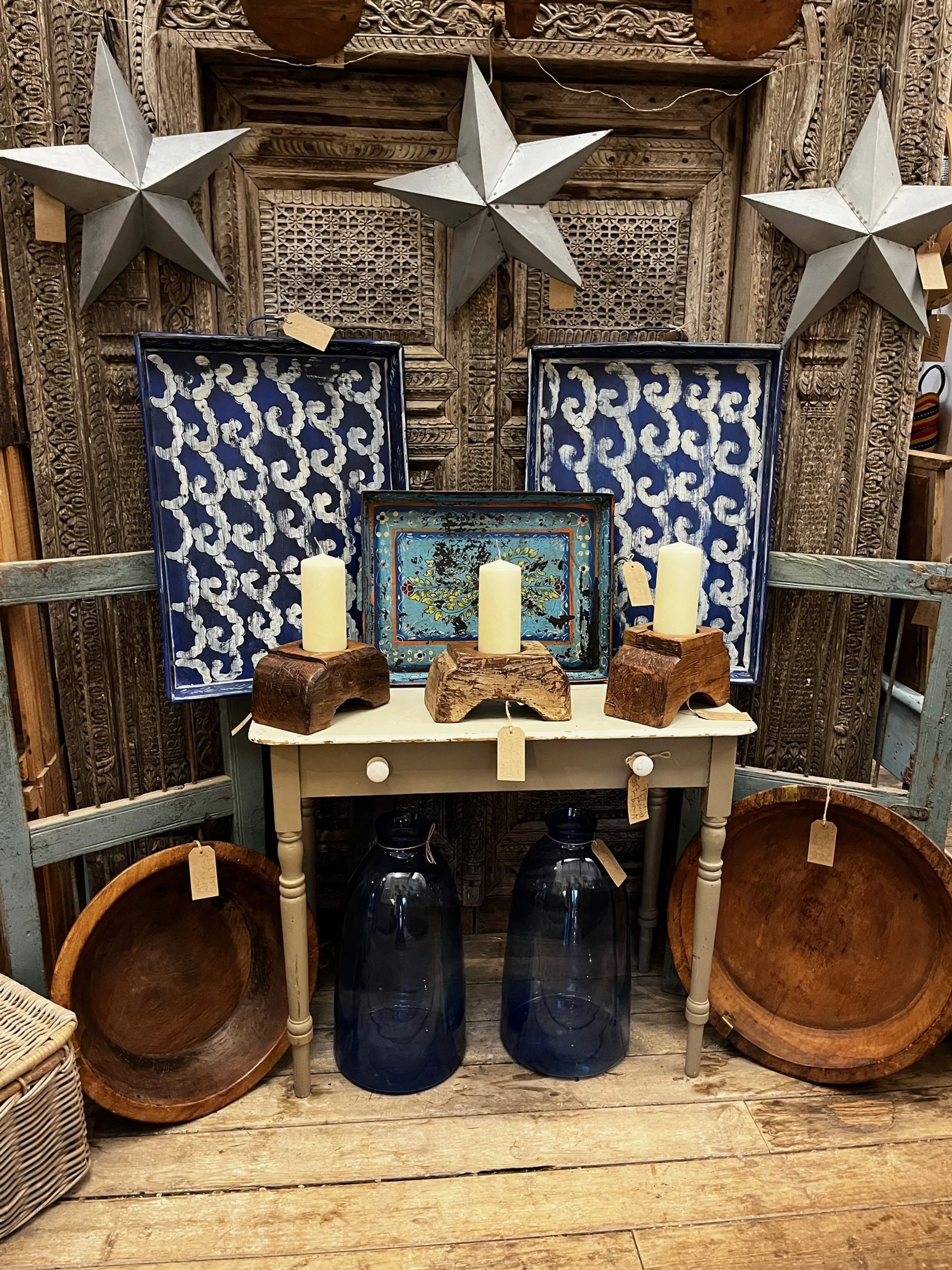 Ornate blue metal trays and wooden candle holders from India