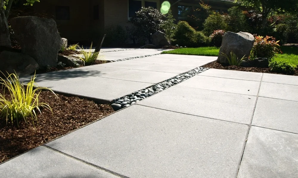  Boulder groupings guide feet as the  modern paver walkway  jogs. 