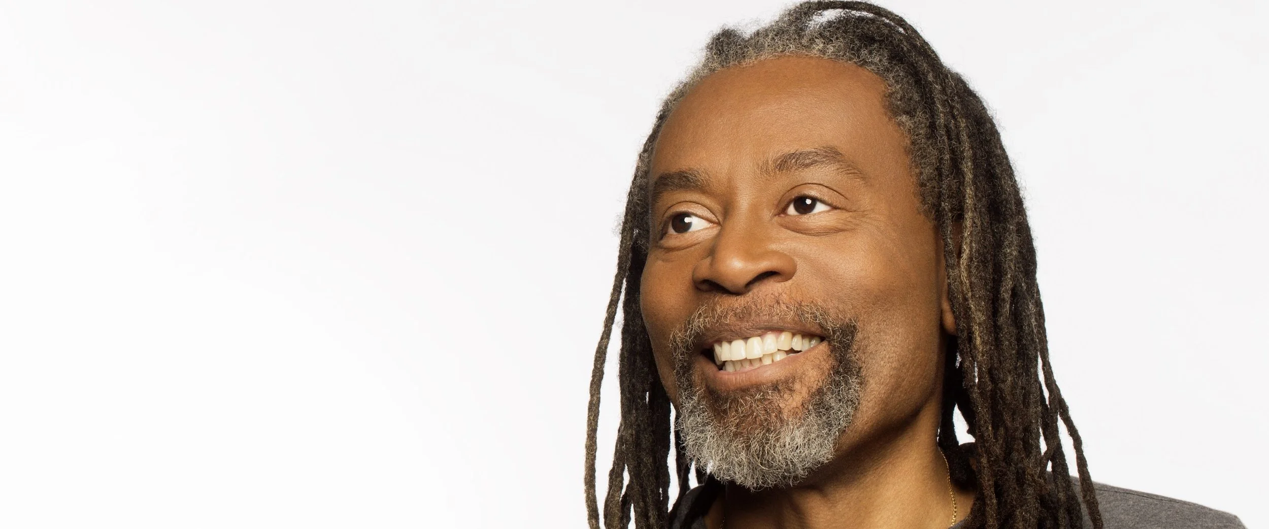 Portrait photo of Bobby McFerrin Smilling and looking off to the left.
