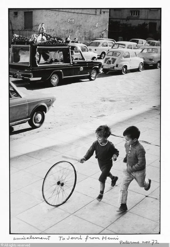 "Palerme" (boy with wheel) by Henri Cartier-Bresson, 1971/1972. Trying to respect copyrights and all, I found this digital copy here on the internet.