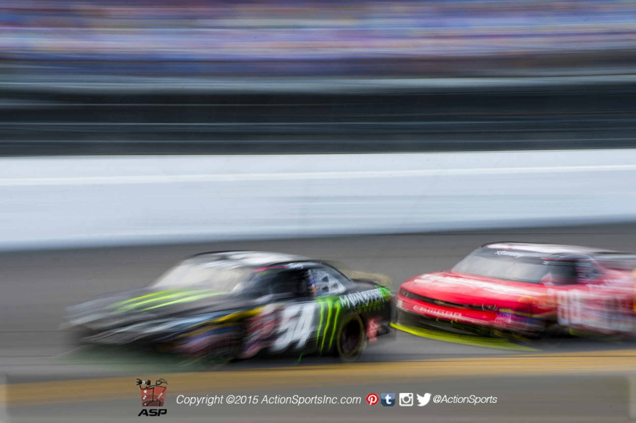 Kyle Busch (54) leads Dale Earnhardt Jr. (88) along the front stretch during the Alert Today Florida 300 
