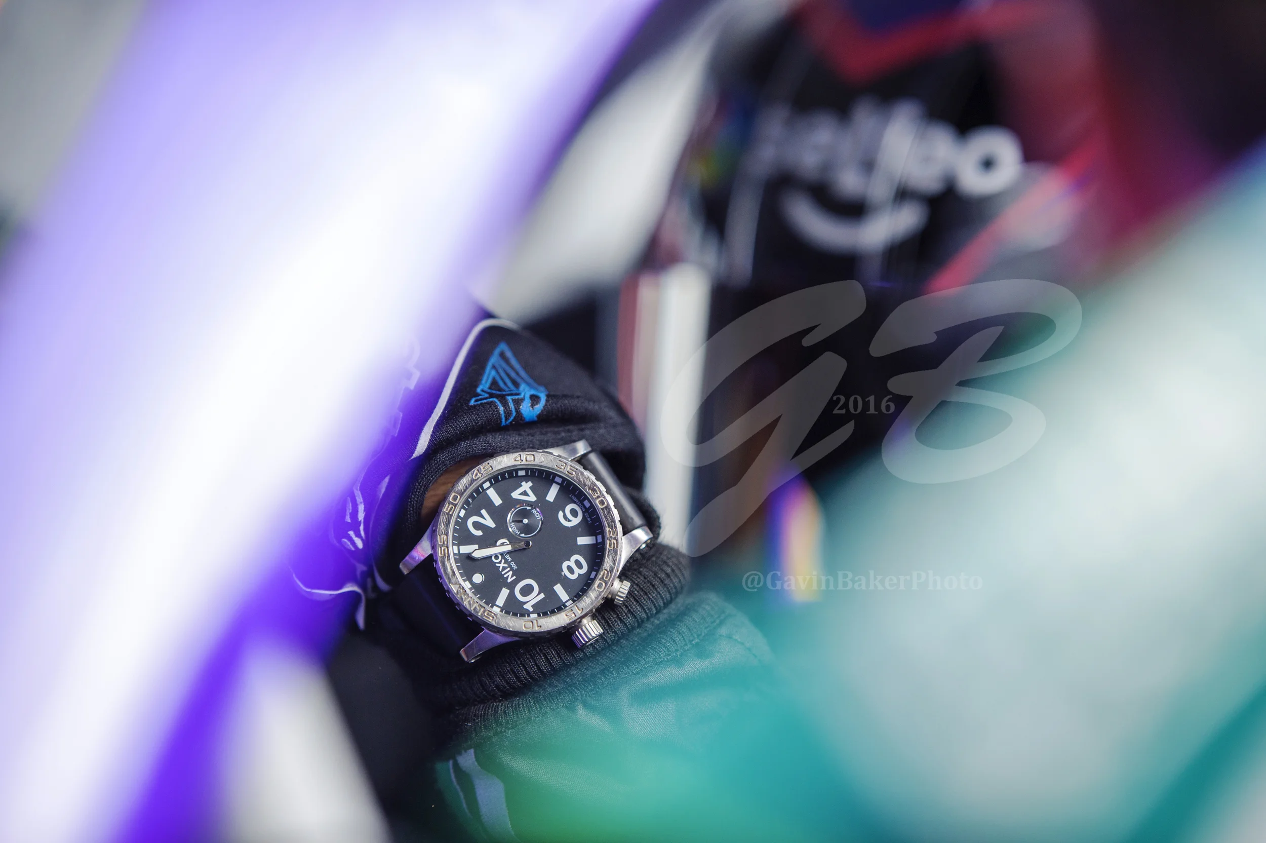 Darrell Wallace Jr shows off his Nixon watch as he backs the #6 Selfeo Ford out of the garage