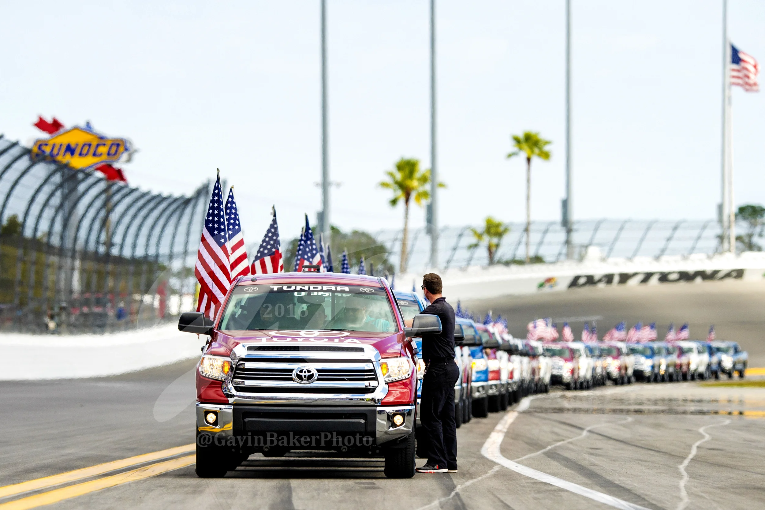 The line of Toyota Tundras wait for the signal to pick up the drivers after they have been announced for a parade lap around Daytona