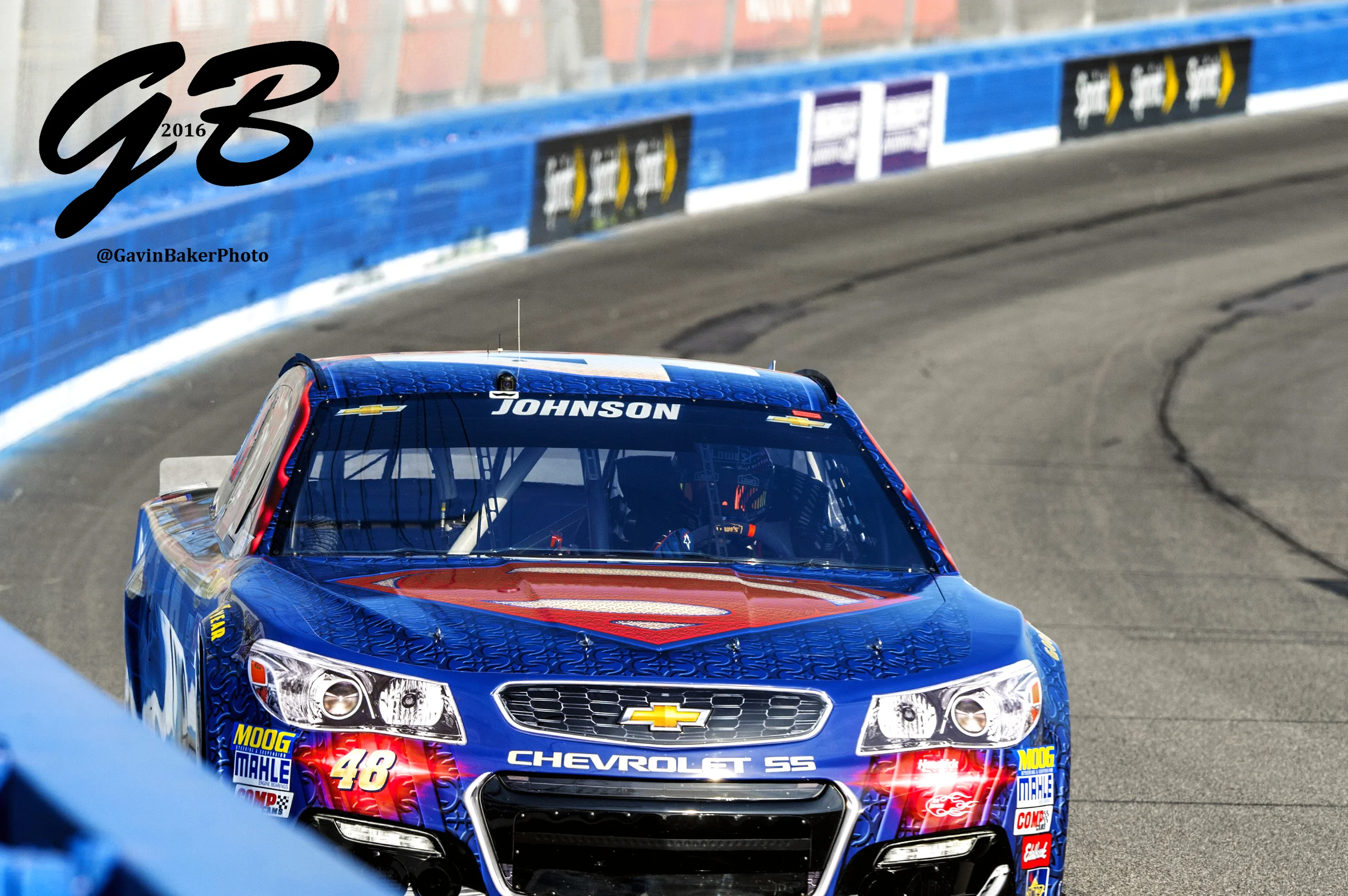 Jimmie Johnson tests the limits of his #48 Superman/Lowe's Chevy as races through turn two at Auto Club Speedway