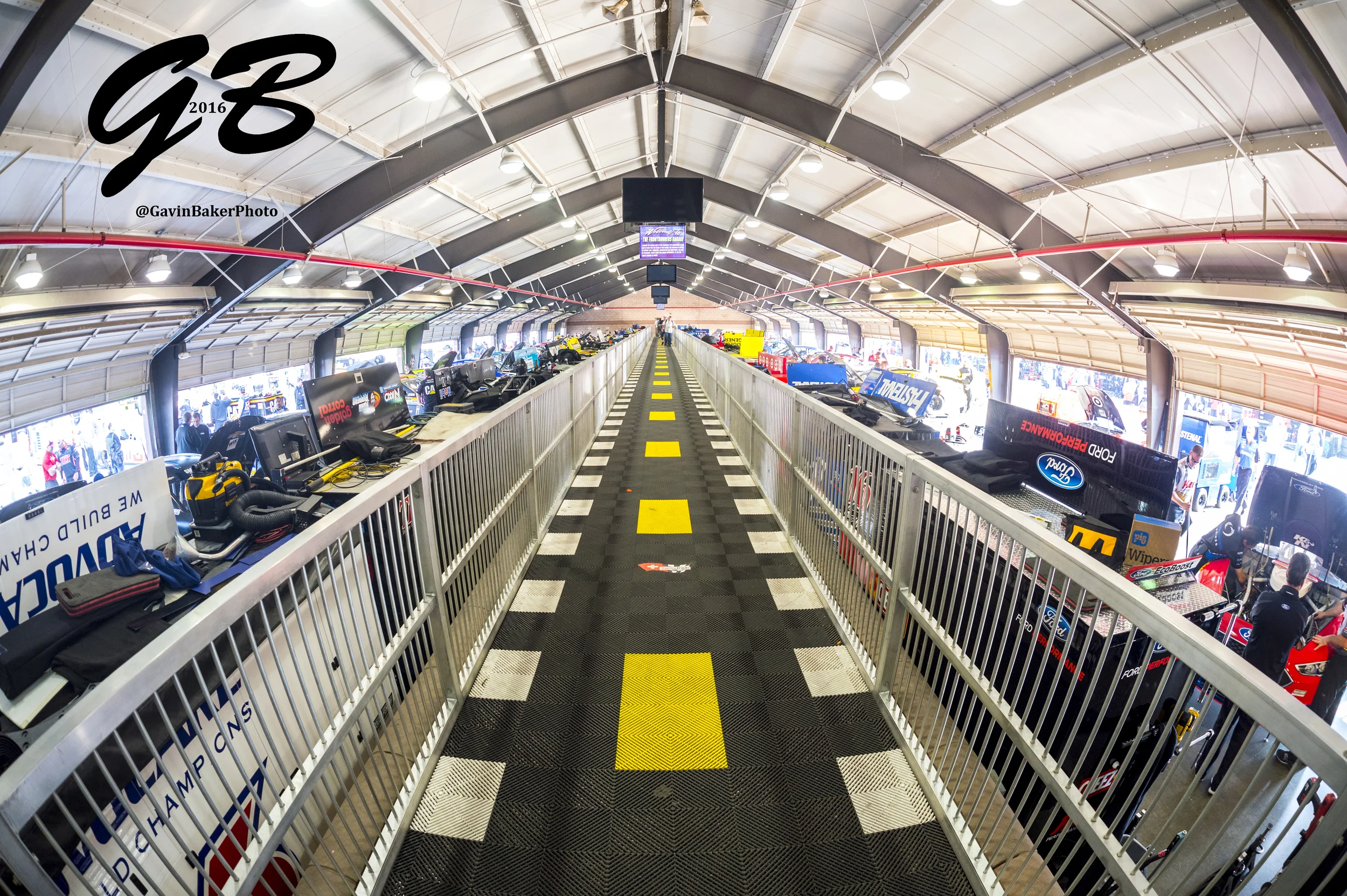A pedestrian cat walk divides the Sprint Cup garage to make better views available to NASCAR pit pass holders.