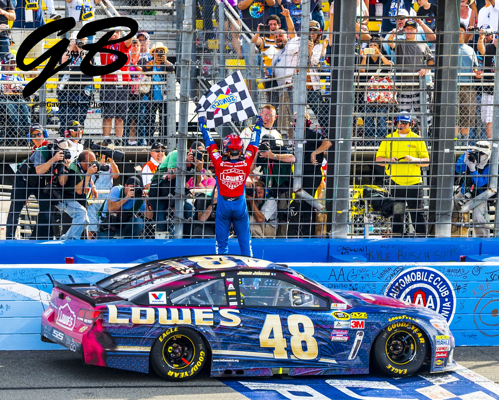 Jimmie Johnson celebrates his victory in front of photographers as he stands atop the #48 Lowe's / Superman Chevy at the start / finish lane after wining the Auto Club 400 in Fontana Ca.