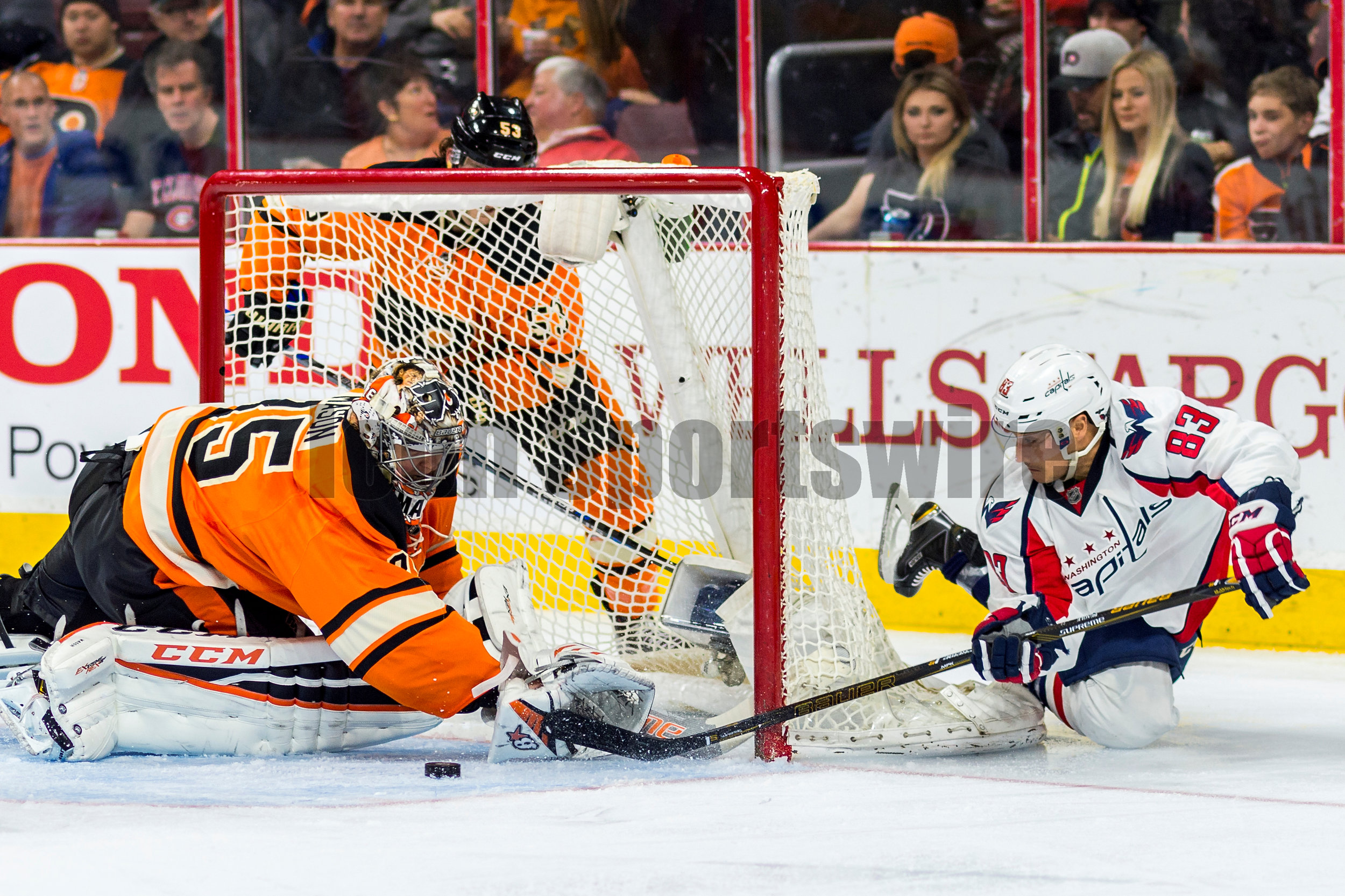  30 March 2016: Washington Capitals center Jay Beagle (83) dives and shoots around the net as Philadelphia Flyers goalie Steve Mason (35) makes the save during the NHL game between the Washington Capitals and the Philadelphia Flyers played at the Wel