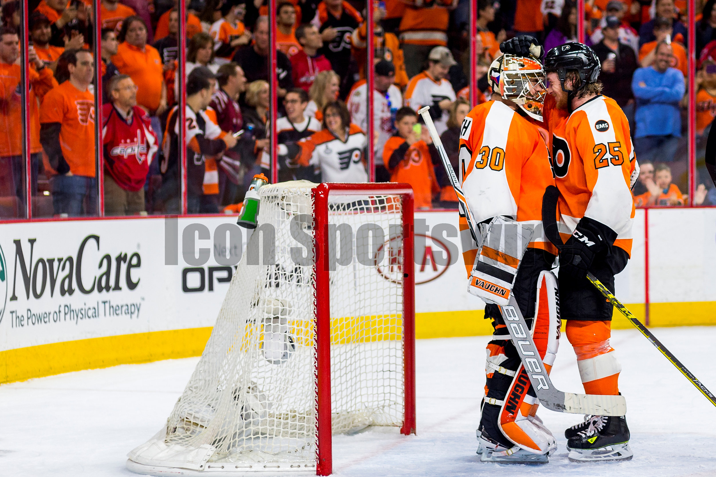  20 April 2016: Philadelphia Flyers center Ryan White (25) and Philadelphia Flyers goalie Michal Neuvirth (30) exchange elations in front of the net after winning the NHL playoff game between the Philadelphia Flyers and the Washington Capitals played