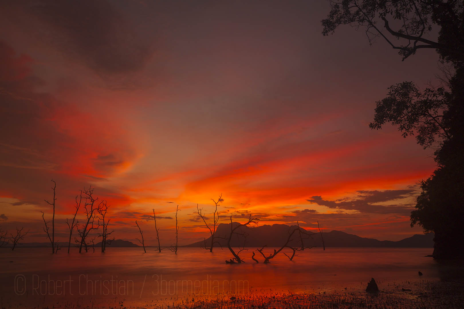 Beautiful sun setting behind the Santubong peninsula seen from Bako National Park.