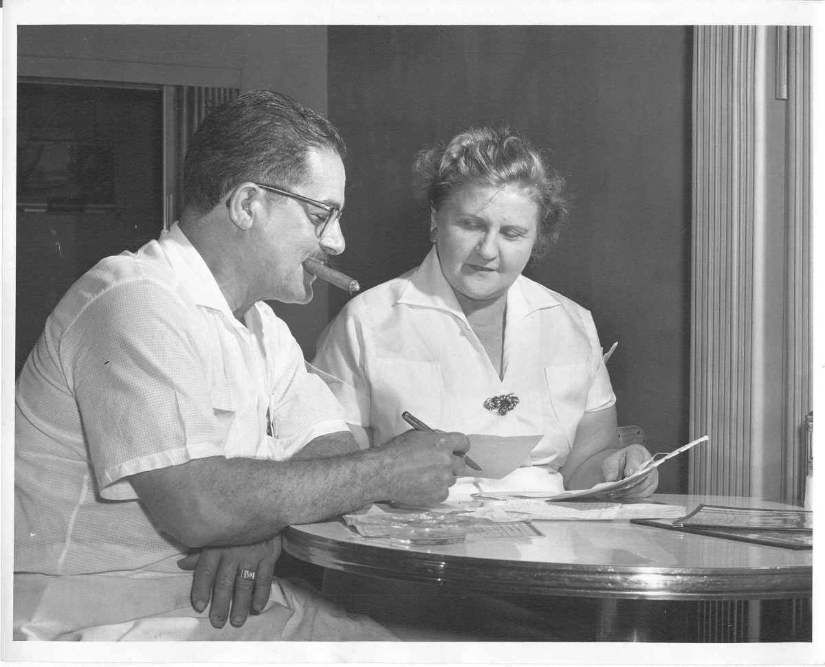 nat and mary carbone paying bills at their first restaurant.jpg