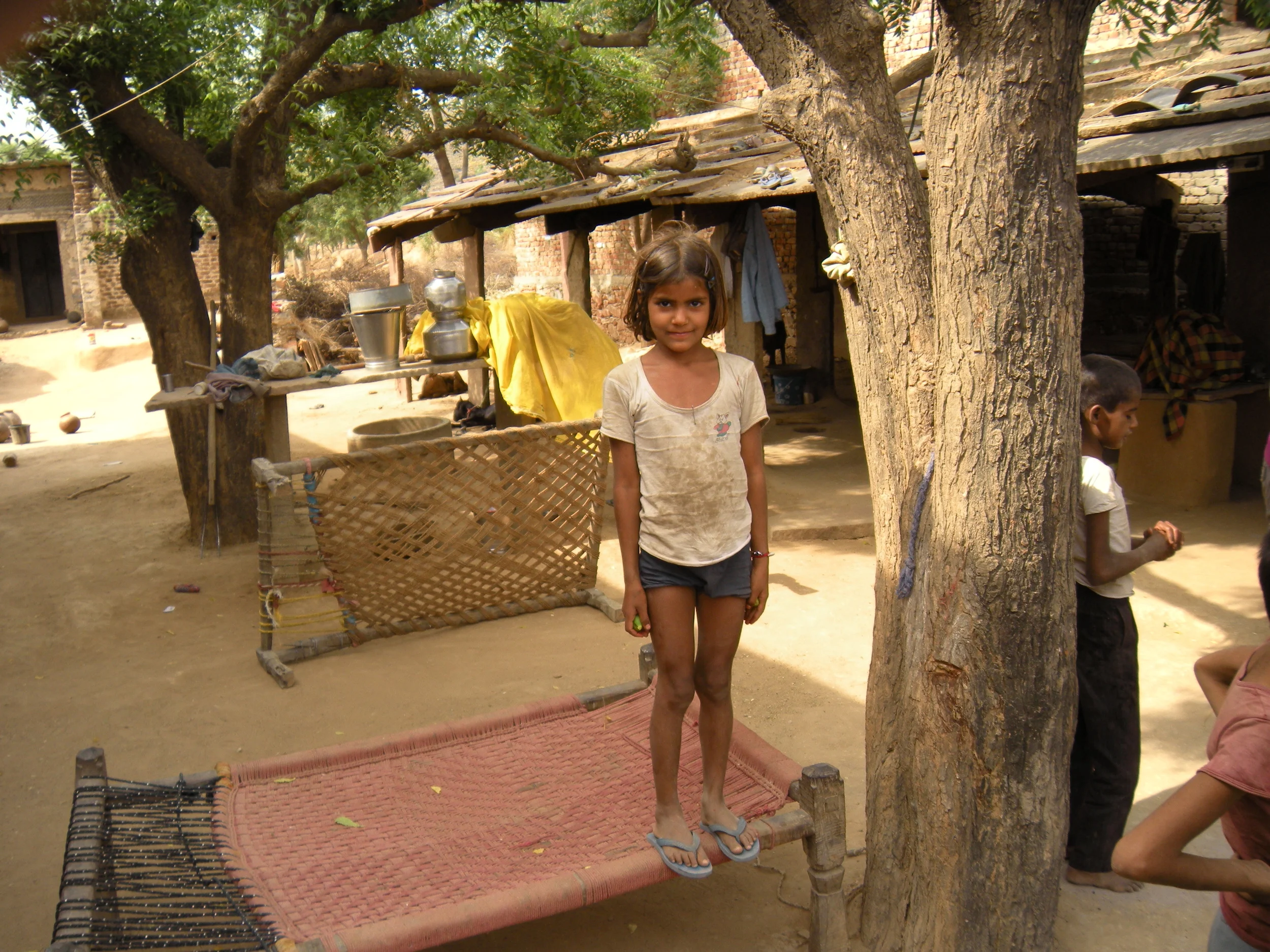 Young girl at a village pottery maker's home.