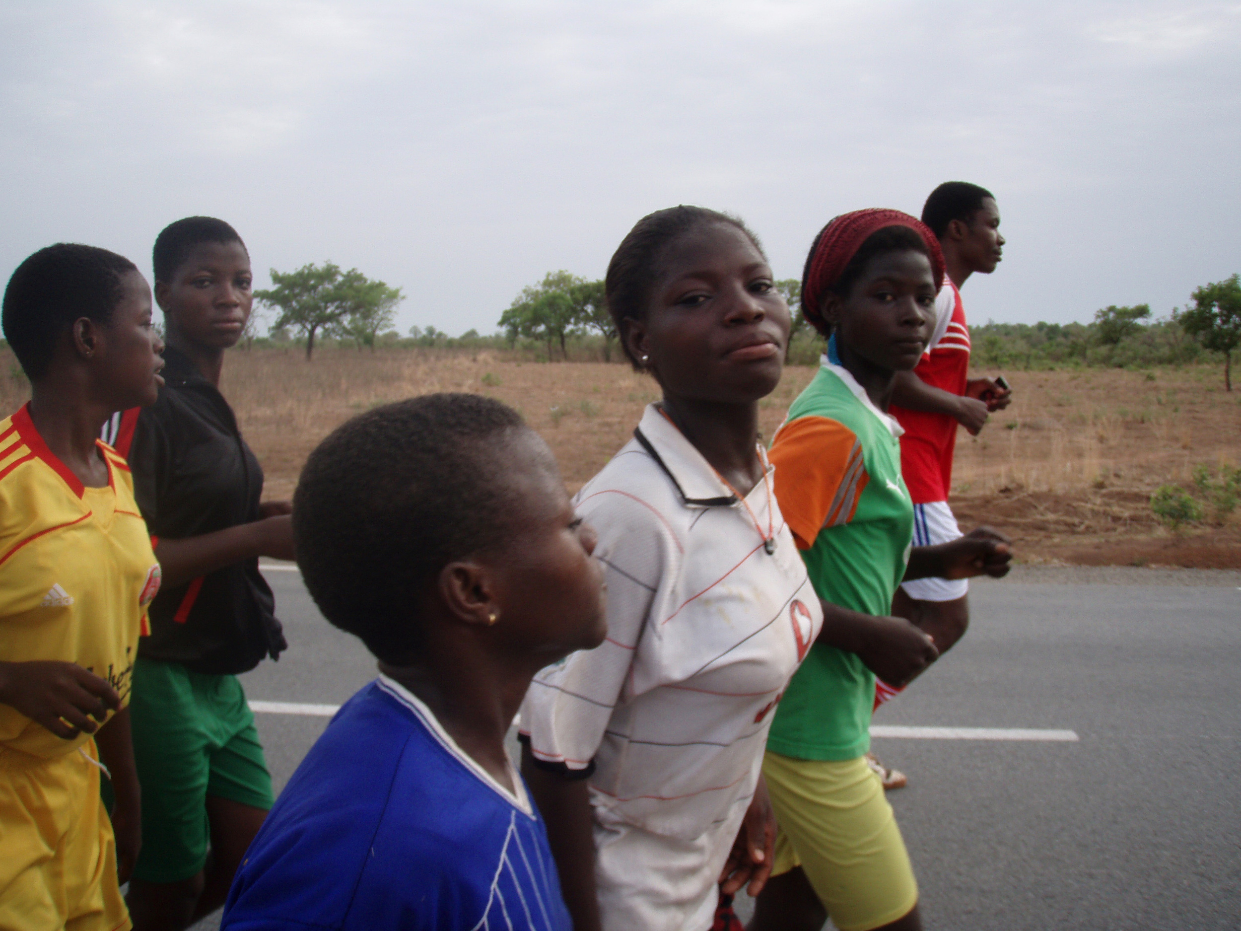  Girls run along the two-lane national highway on a Saturday morning. 