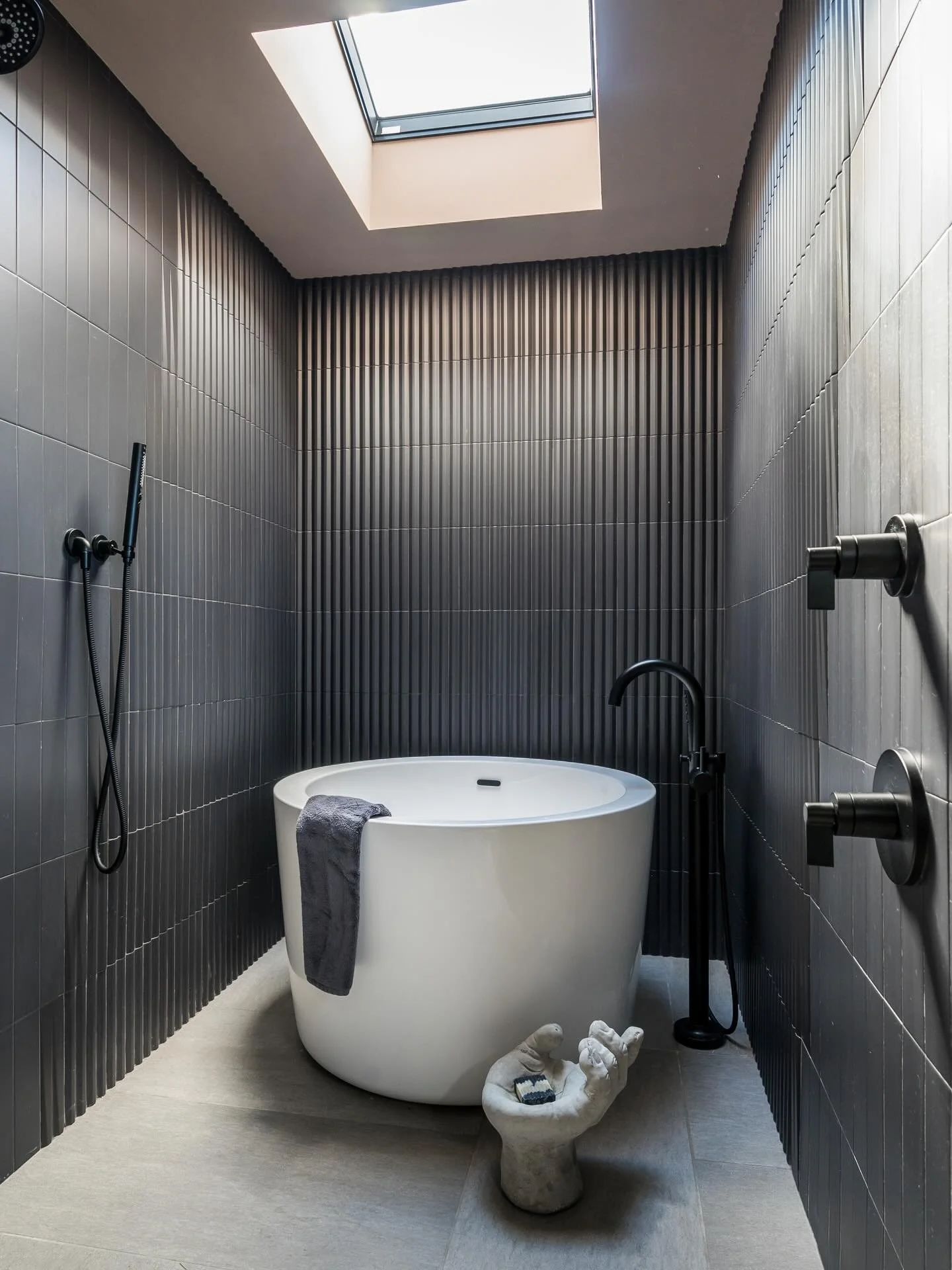 Drenched in drama. 🖤 Embracing the moody side with black walls and a sky full of light. This is not just a bathroom, it&rsquo;s a sensory retreat. 

#bathroomrenovation #bathroomdesign #blacktile #tilework #showerinspo 

Contractor: @rgh_development