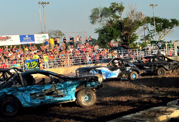 Travis Moyer (center) drives the car that he built for the demolition derby in Kansas. Frank Morris/KCUR