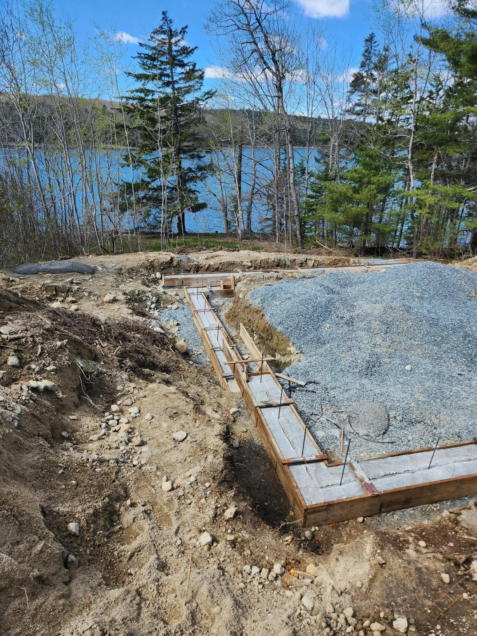 Lots of movement on the property of late. Drove up and back last weekend to firm up the next steps: Concrete footings in, plans for windows and doors confirmed - this is going to be a full walkout basement that goes right into the woods and down towa