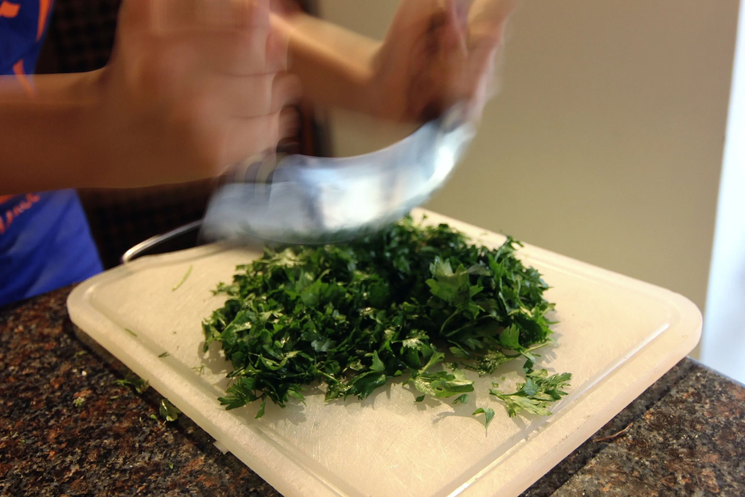 Prepping the herbs with the "bellydancing" knife. (Using it properly feels like a full body workout).