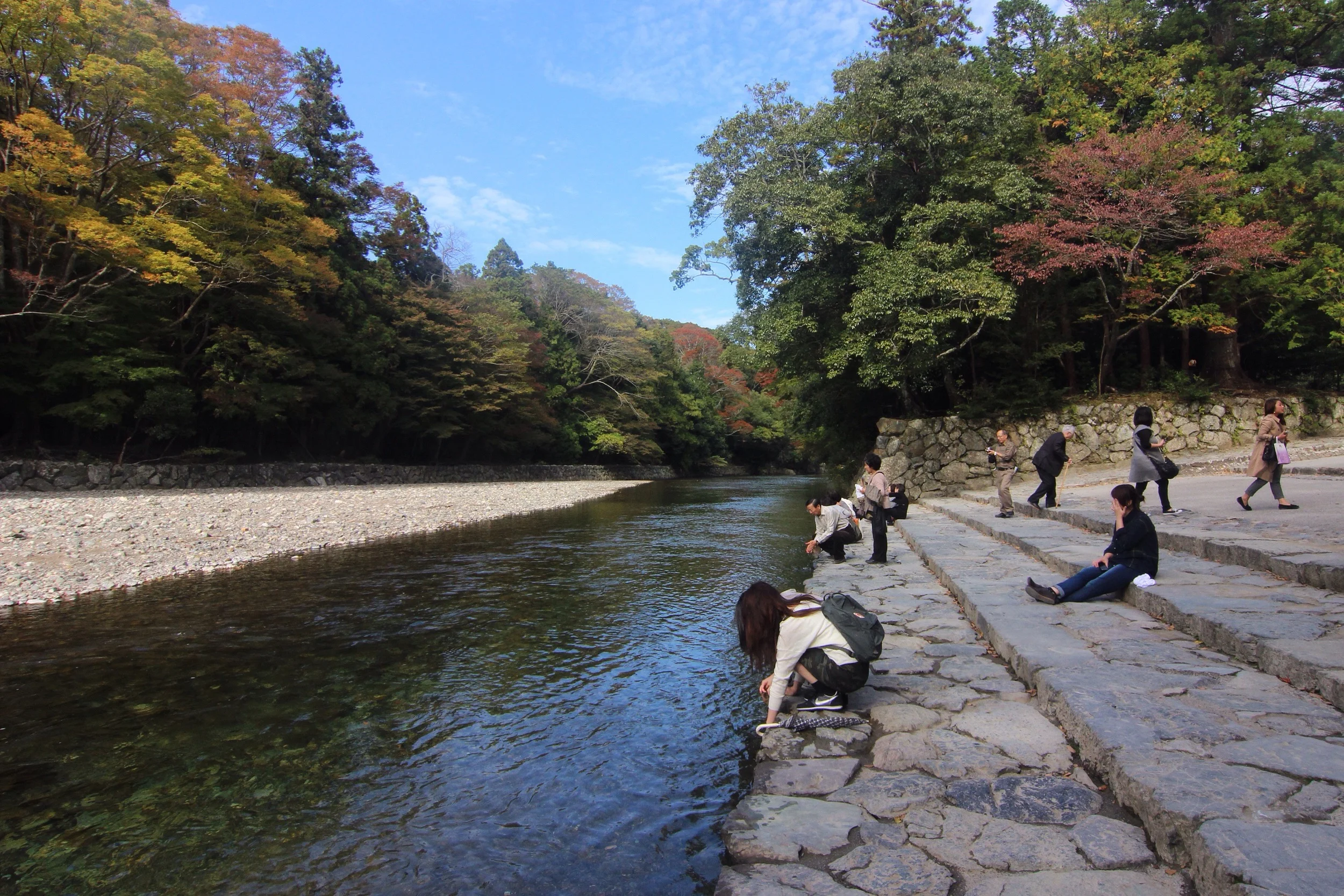 Visitors relaxing by the river.