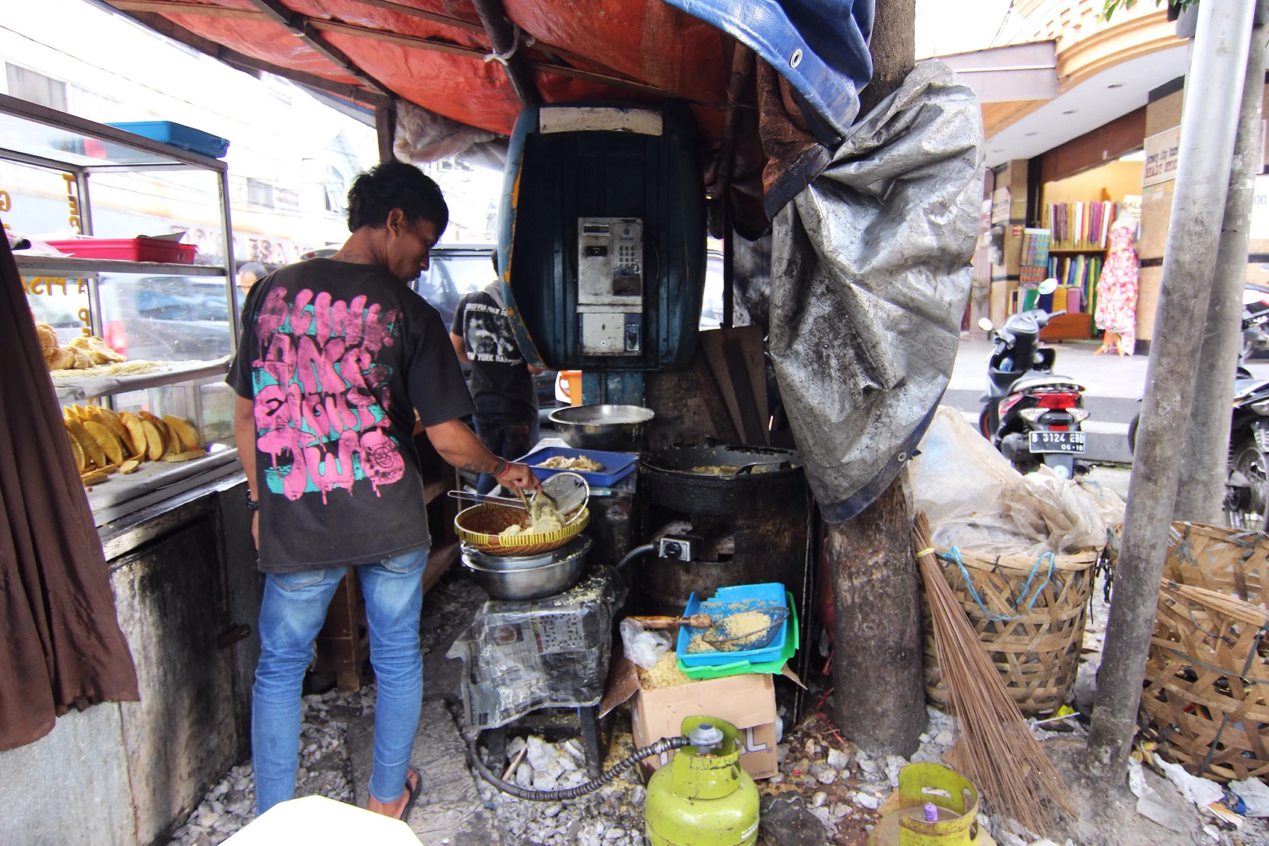 Makeshift kitchen. I like the dilapidated payphone.