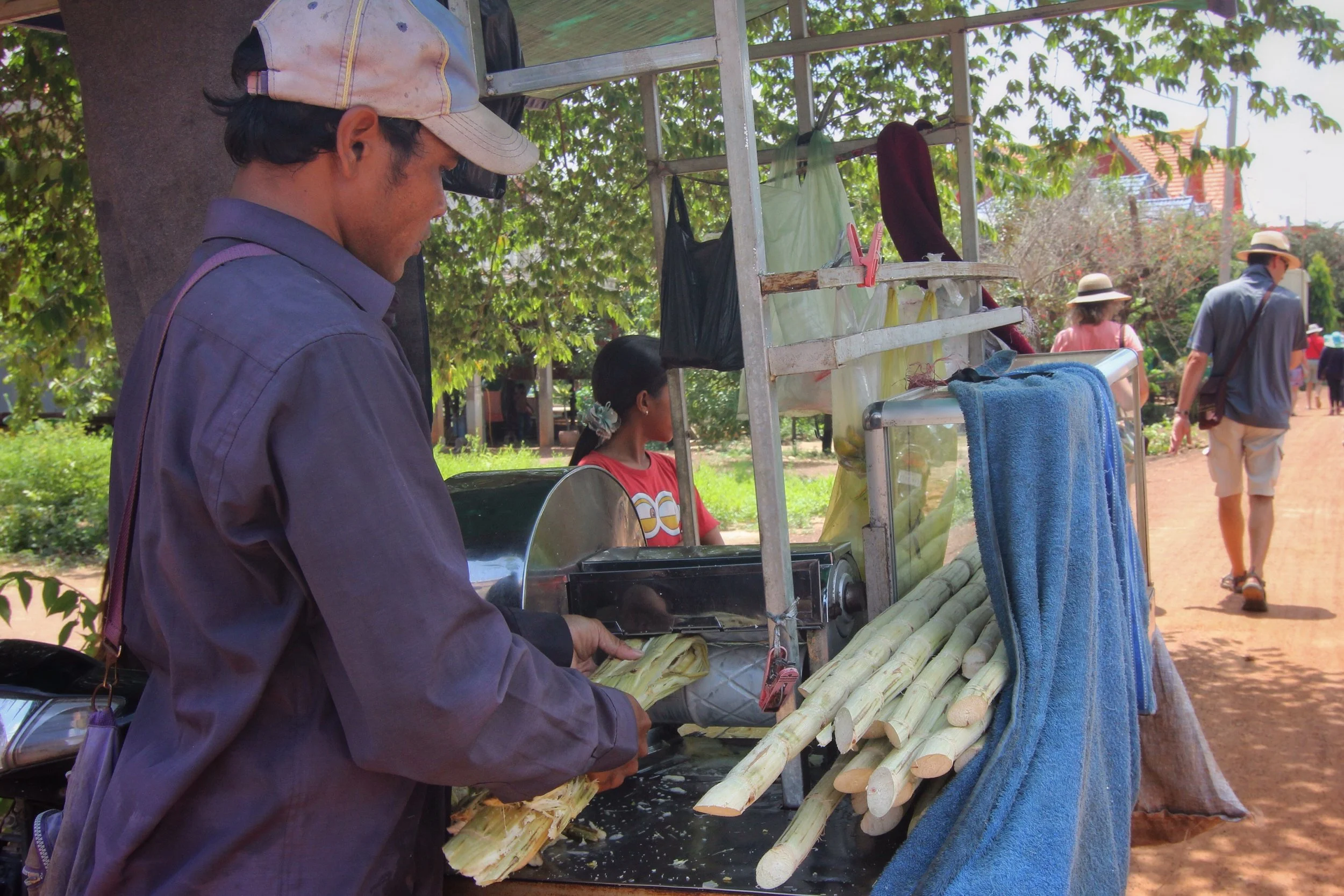 A man juicing sugar cane.