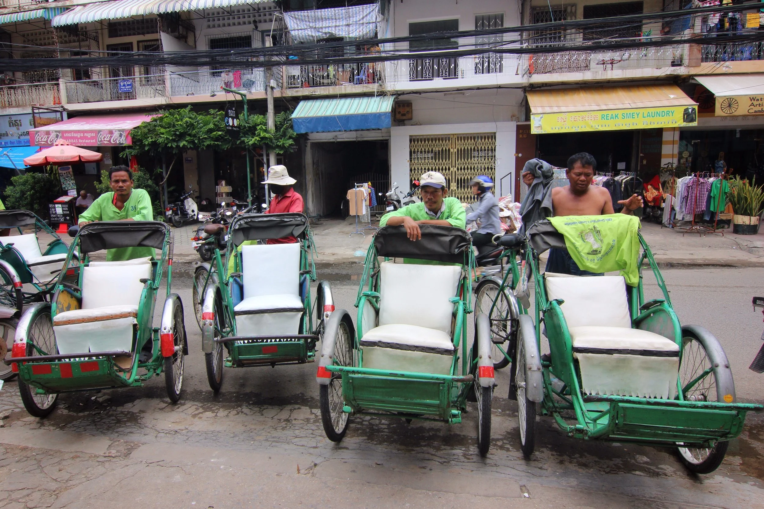The cyclo drivers sizing us up. I had the sense that they were all jockeying to have me as their passenger because I was the smallest.
