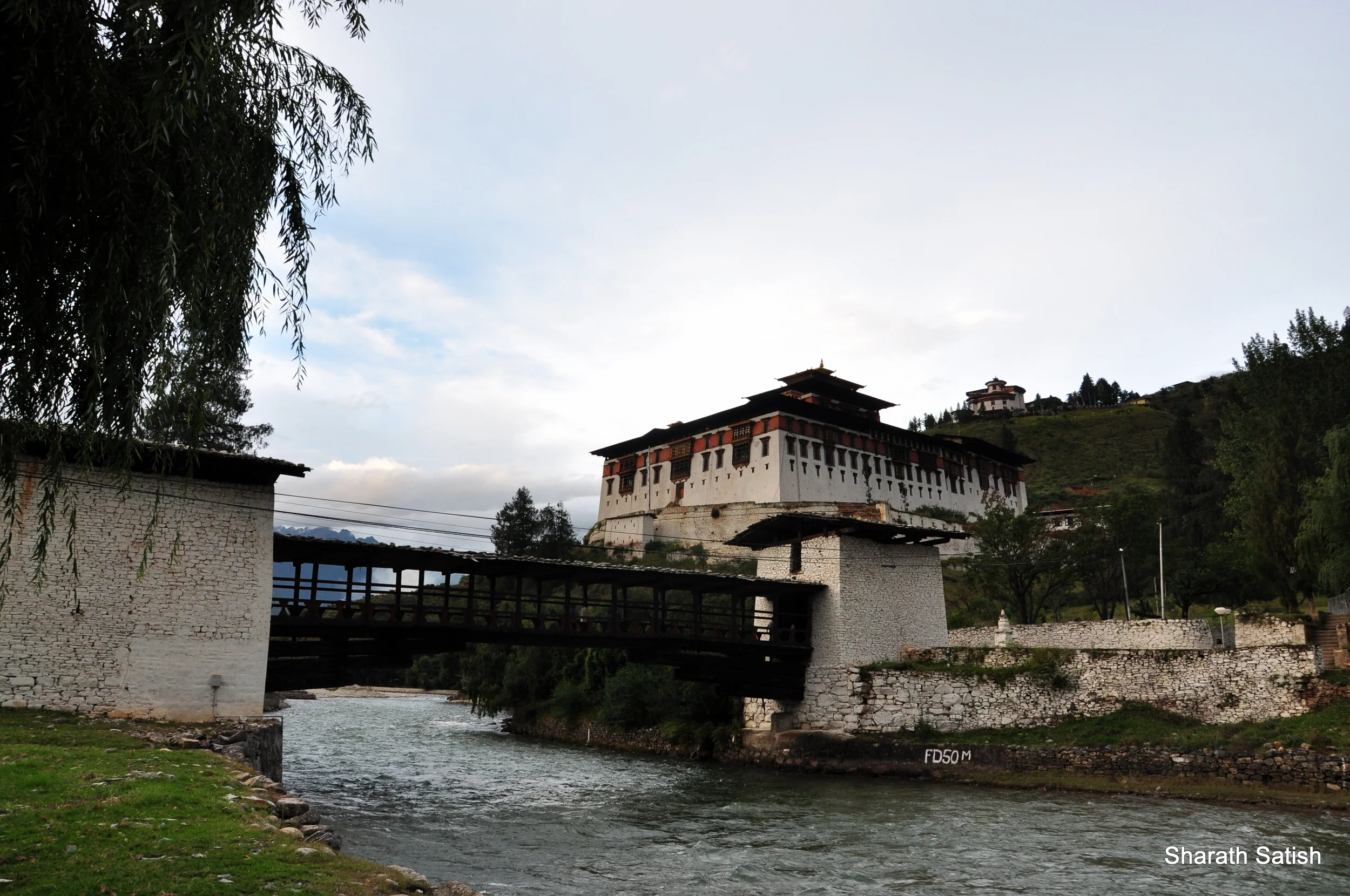 The bridge leading to it and the Rinpung Dzong (National Museum also visible at the back)