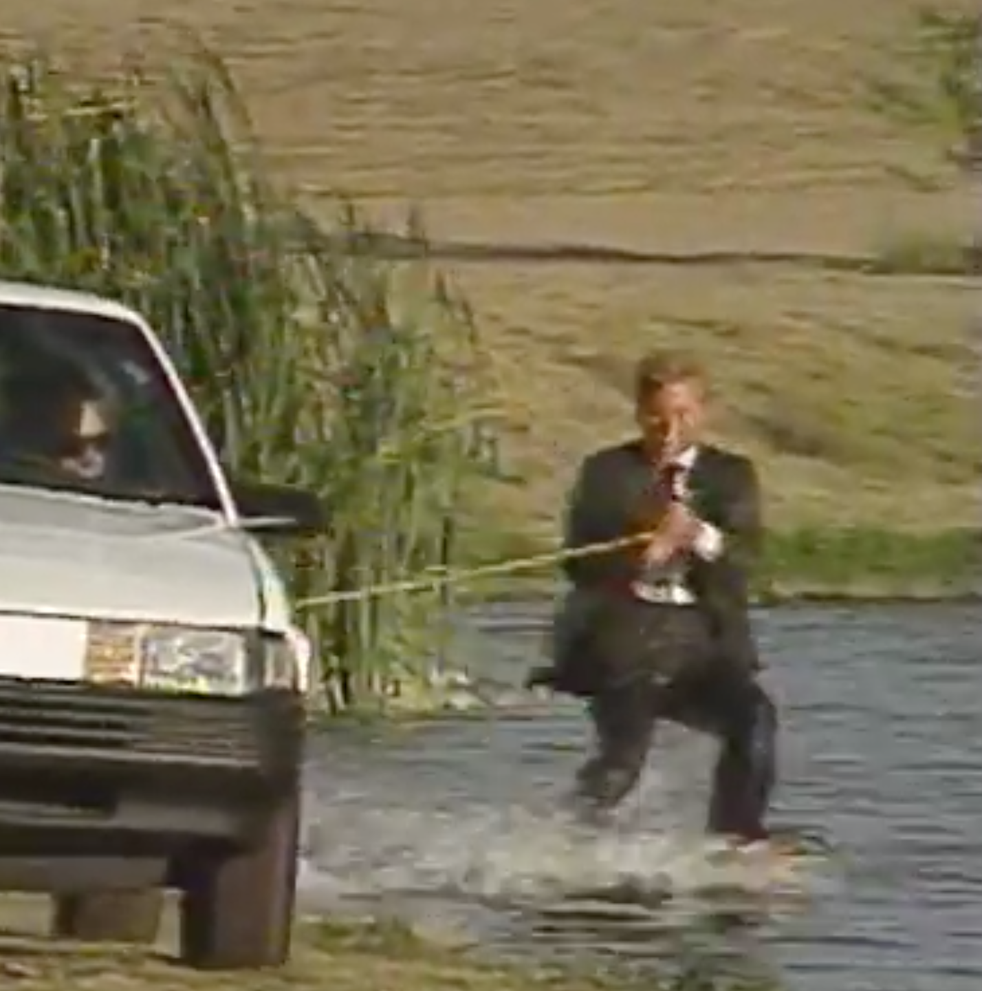 It's Sweeps! Weatherman Skis Behind News Car