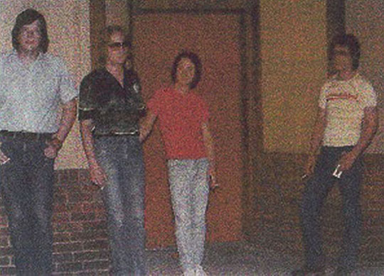 The band standing in front of The Emporium in Peoria Heights in 1979.