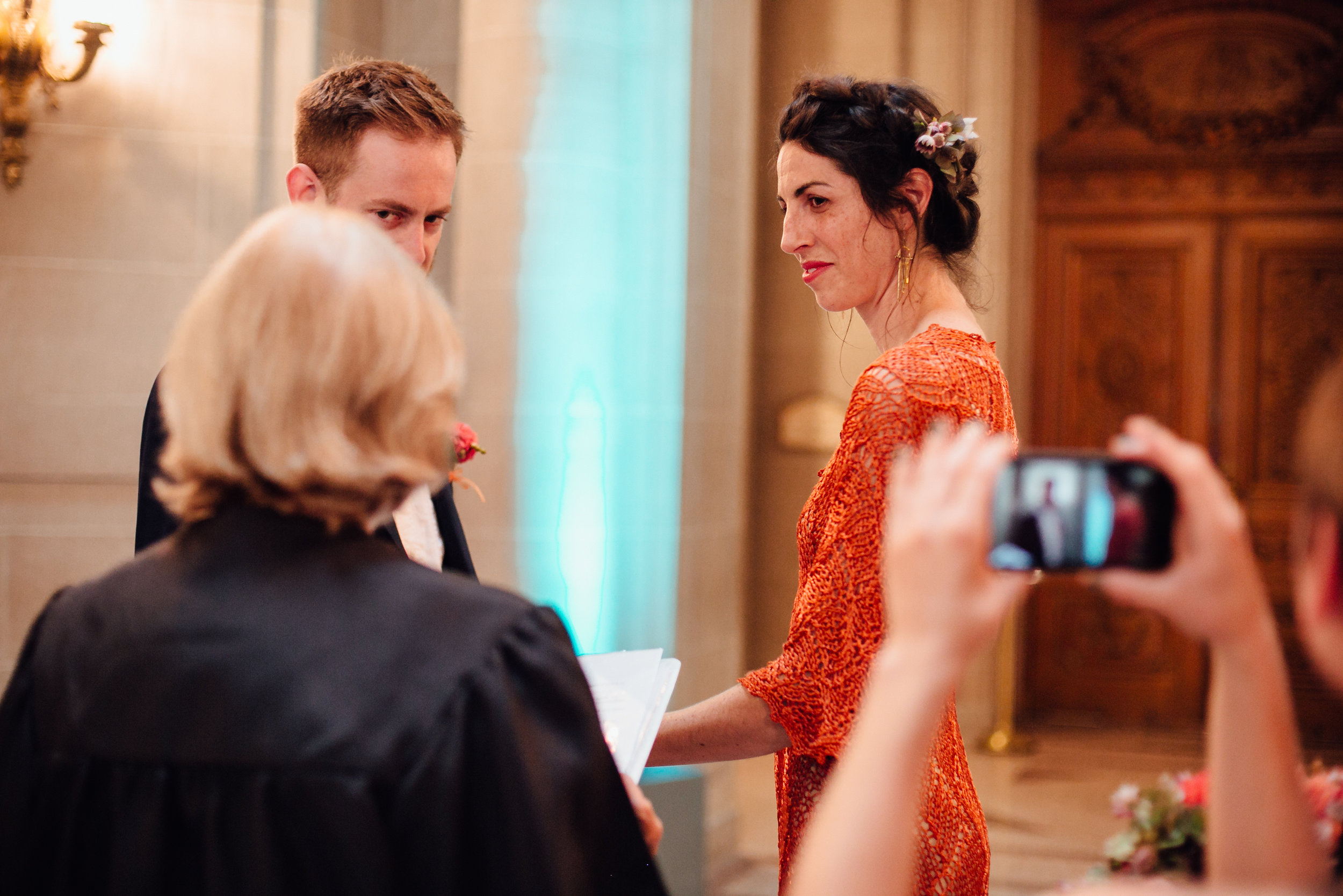  An intimate San Francisco City Hall ceremony, featuring an alternative bride in a bright orange dress. 