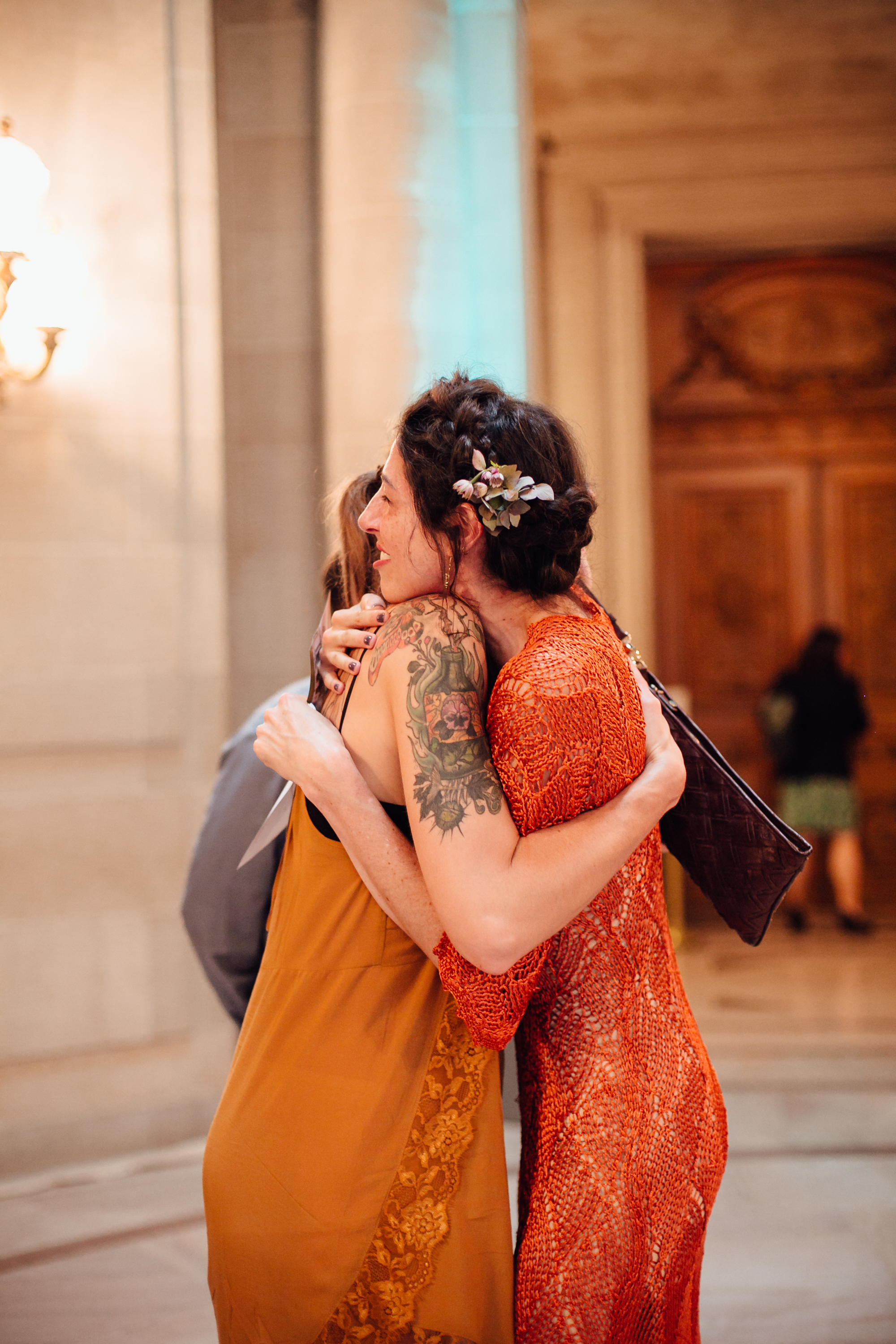  An intimate San Francisco City Hall ceremony, featuring an alternative bride in a bright orange dress. 