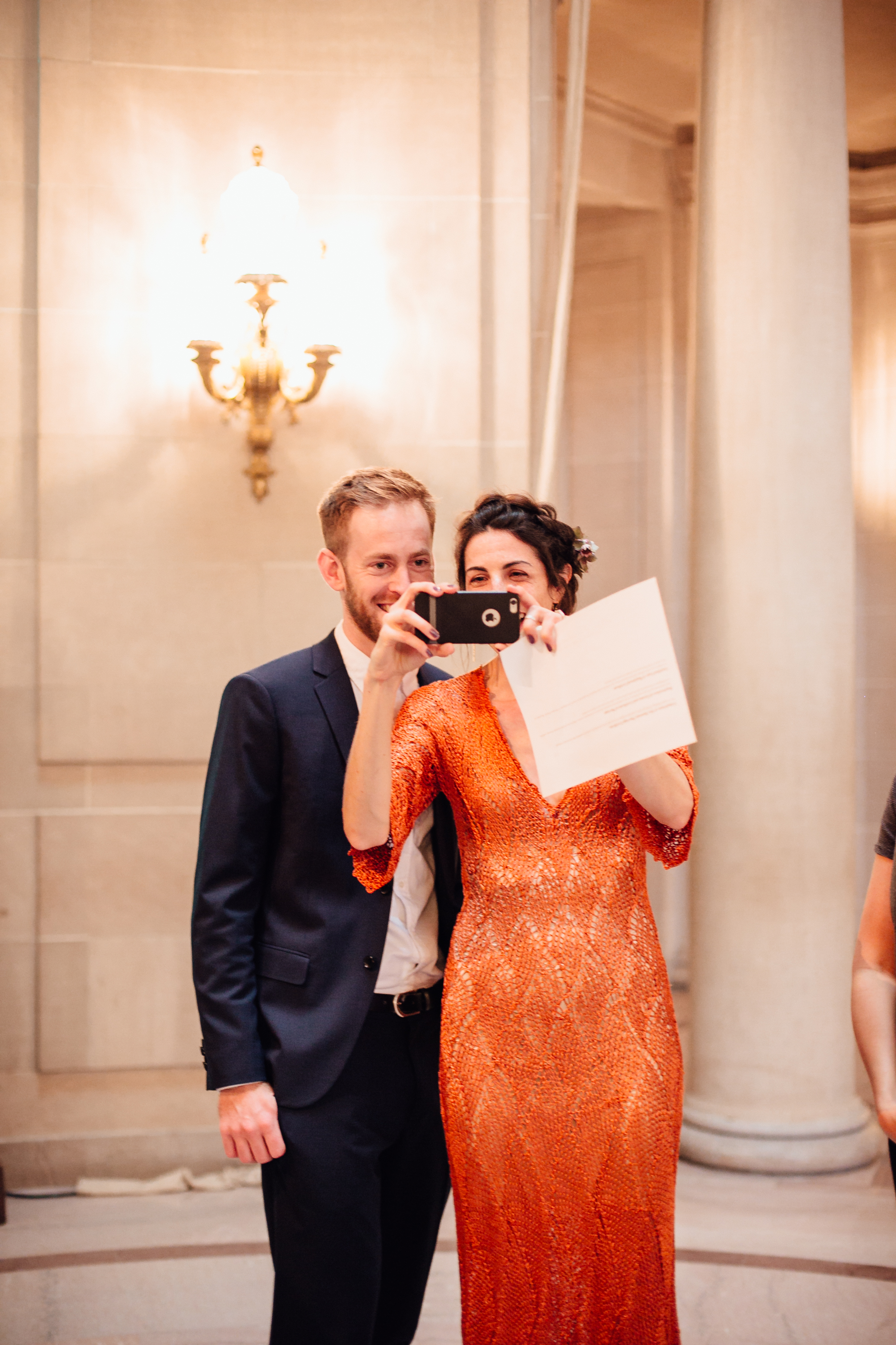  An intimate San Francisco City Hall ceremony, featuring an alternative bride in a bright orange dress. 