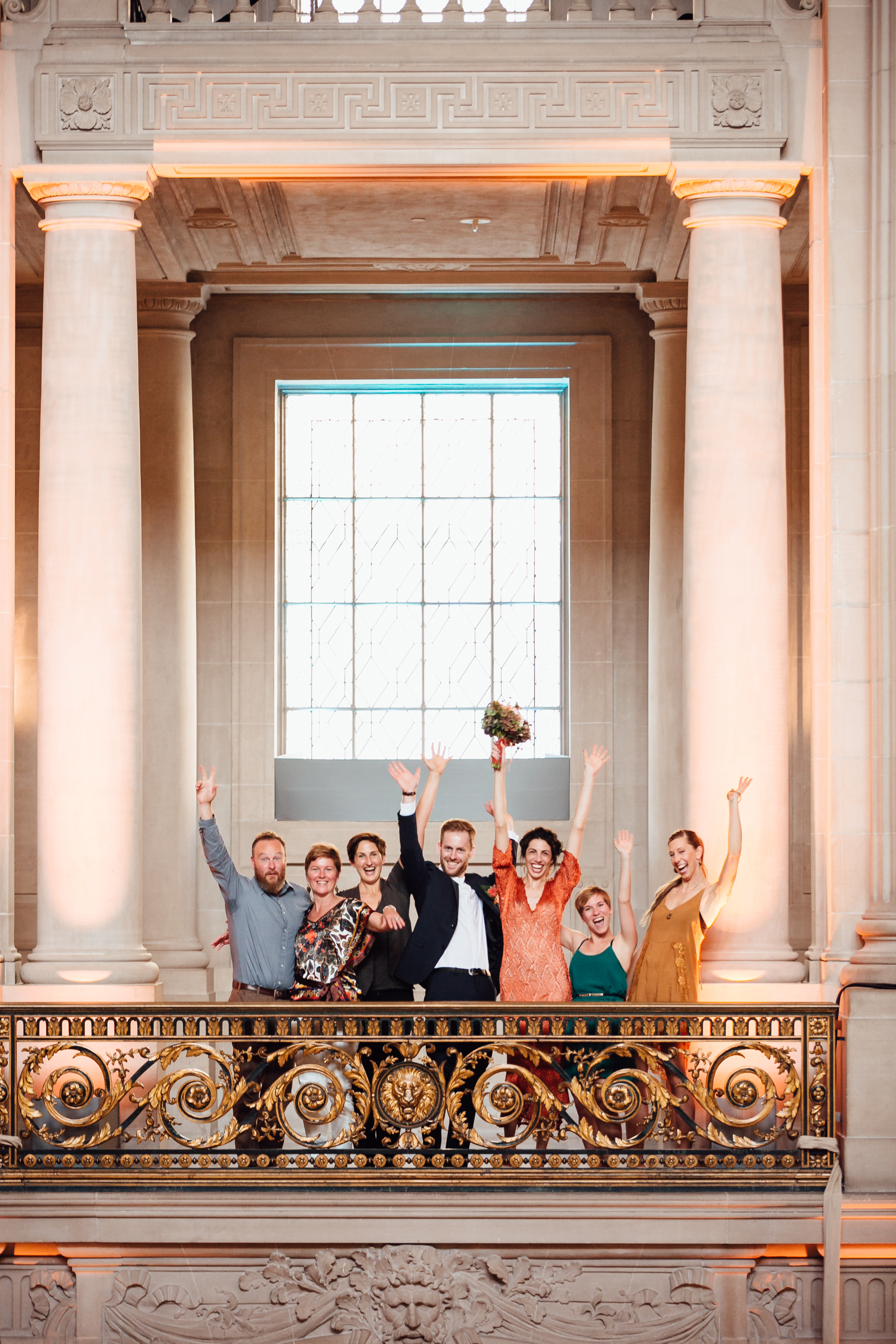  An intimate San Francisco City Hall ceremony, featuring an alternative bride in a bright orange dress. 