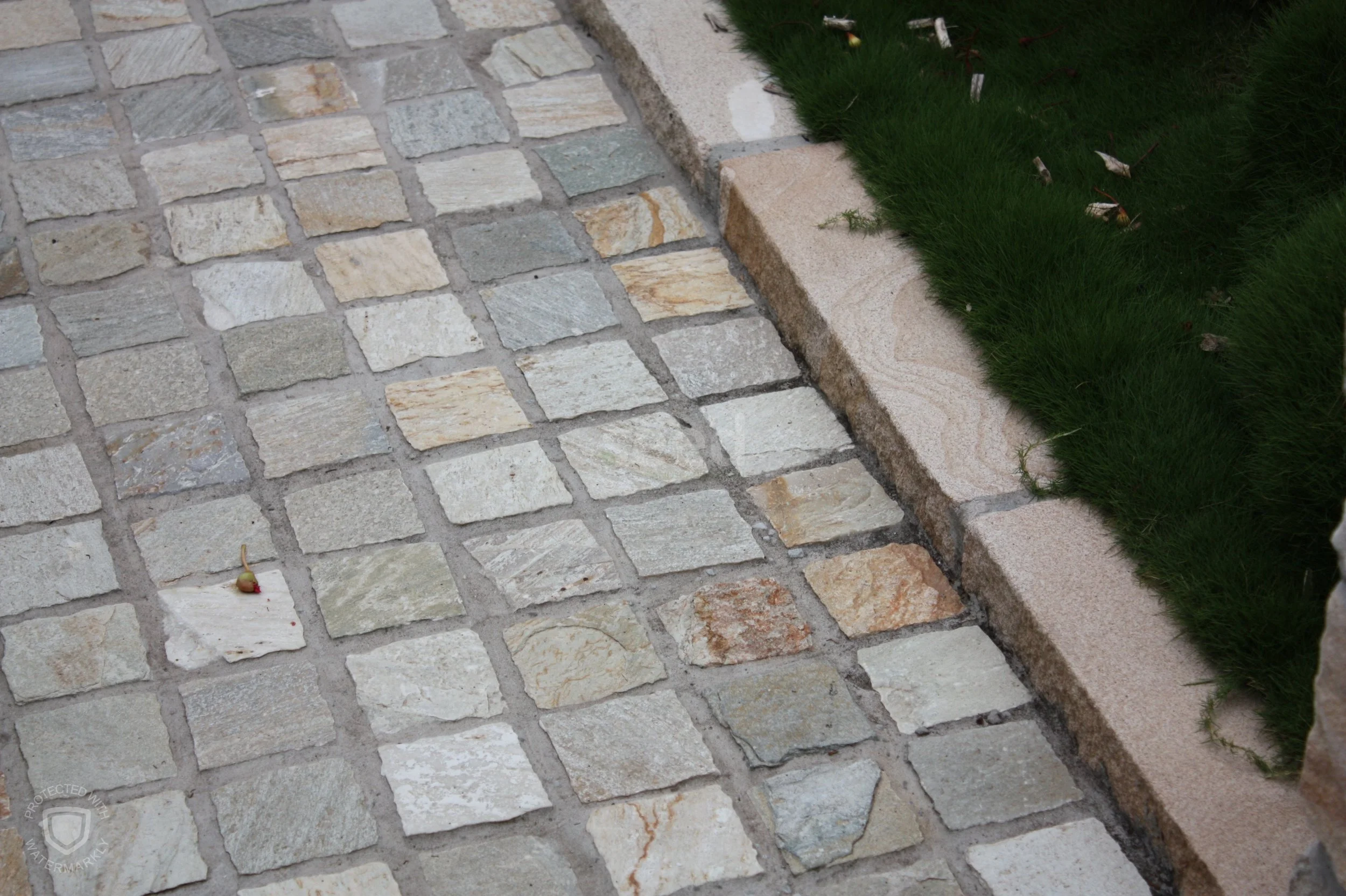 A change in paving design helps distinguish the formal front courtyard, or foyer, from the back garden.