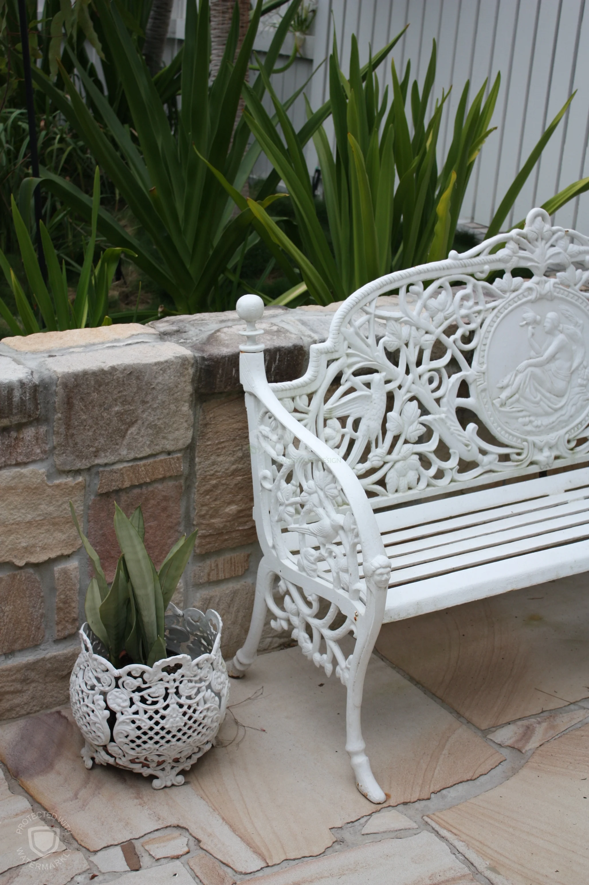 Details such as these white wrought iron pieces help to tie the white slates with the sandstone features.