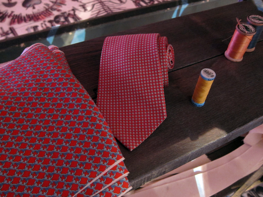  An authentic Hermes tie, silk fabric and the signature orange thread. 