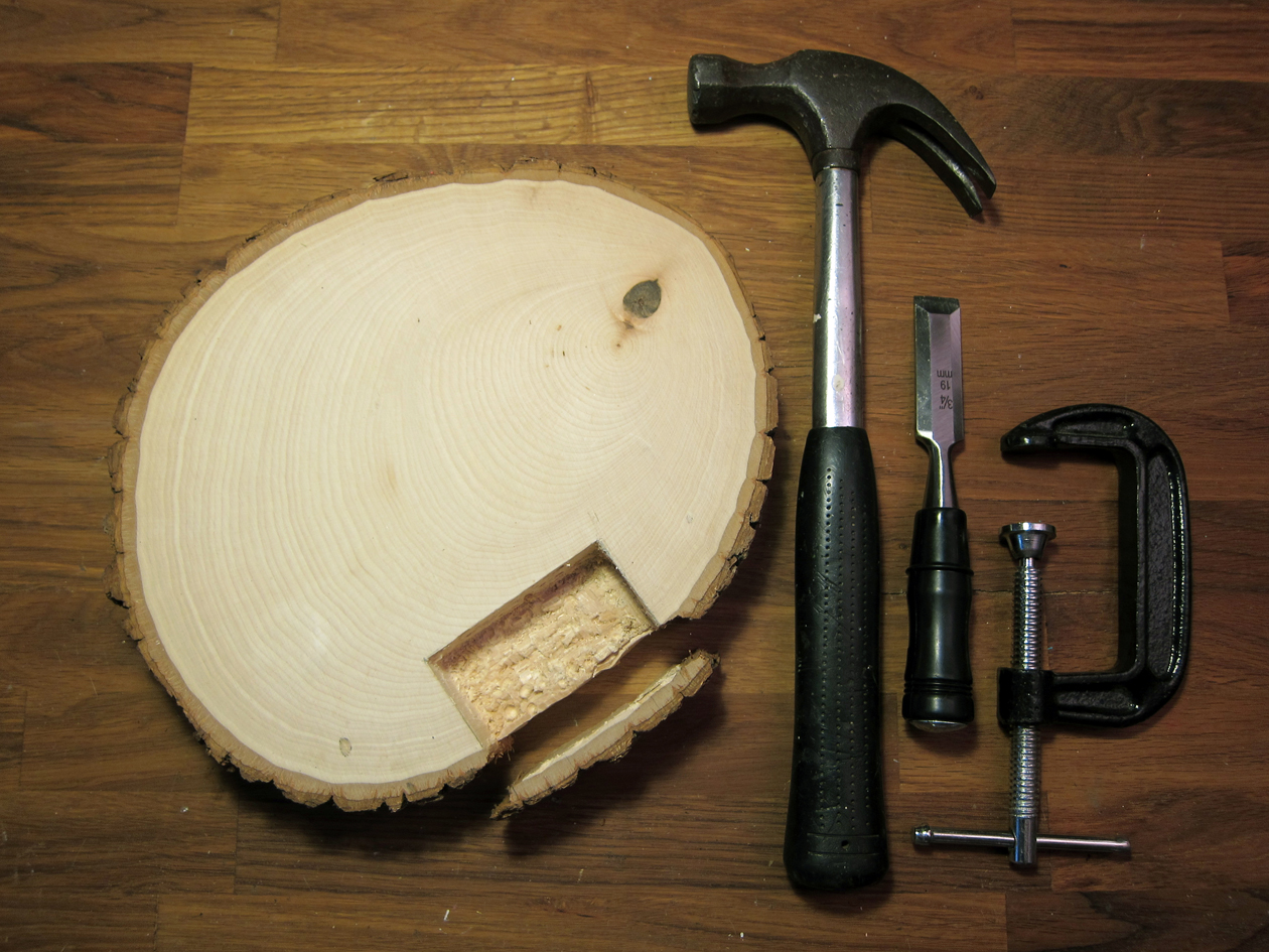 Clamp basswood round to work surface. With a wood chisel and hammer, carefully chisel off the bark edge of basswood next to the tracing marks. Put the bark piece aside.