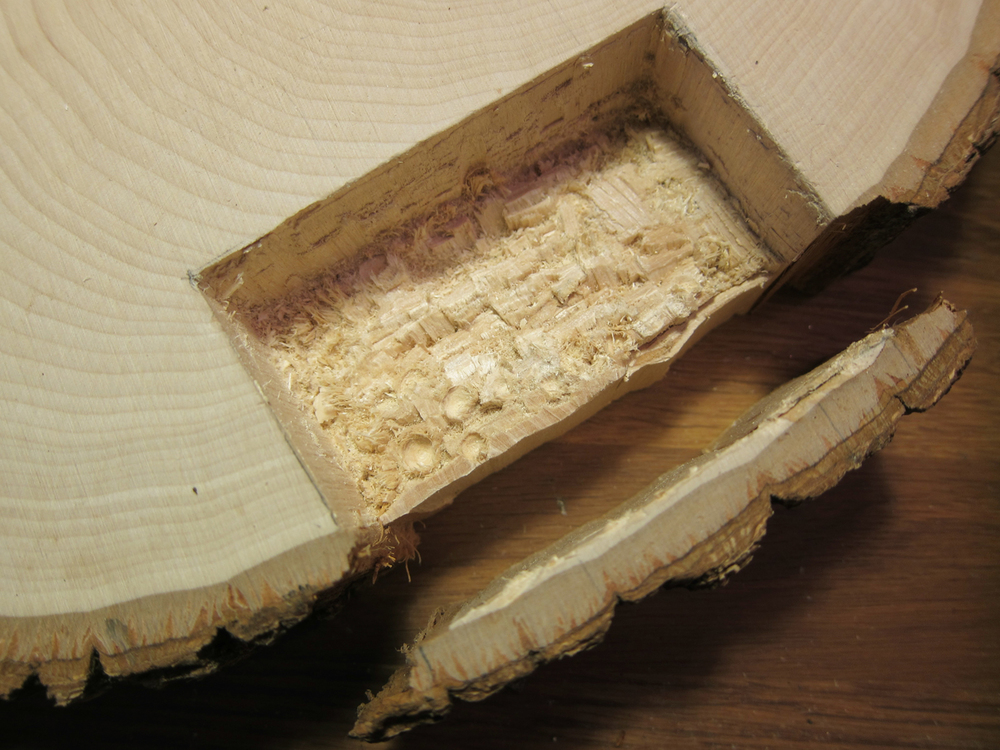  Chisel out the marked space, deep enough so the battery pack sits flush inside the basswood round. 