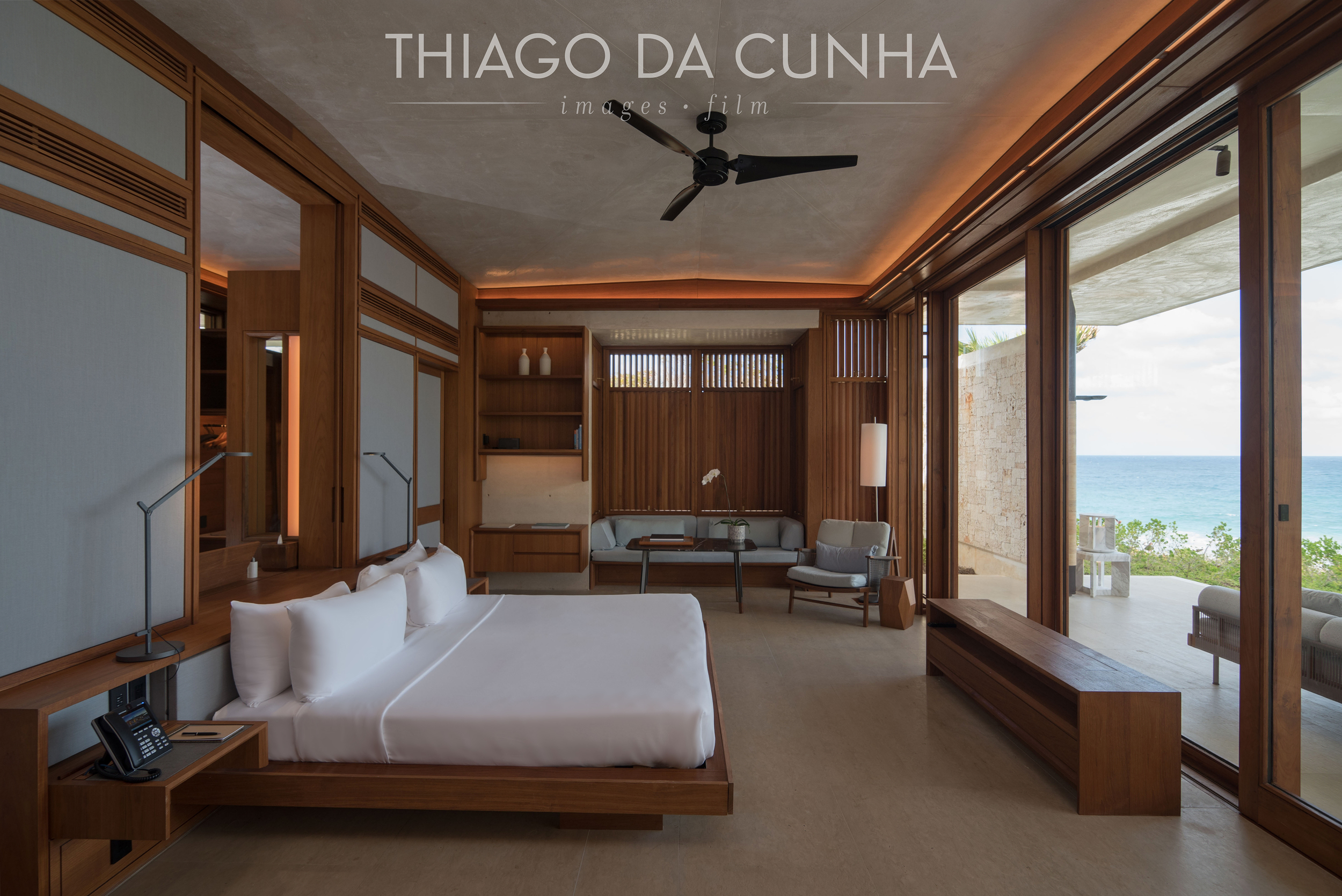 With the automatic popup TV hidden in front of the bed, the guest has a beautiful view of the pool and ocean. Automatic blackout curtains give privacy when needed. Wood is a constant through out the villa. 