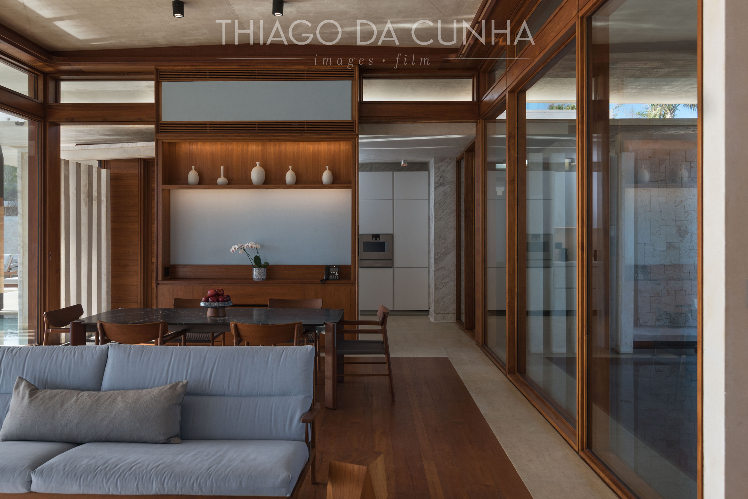 A detailed shot of the living room, dinning room and the kitchen. Again, wood and water is present as well as the large transparent glass windows on both sides of the villa. http://thiagodacunhaphotography.com/