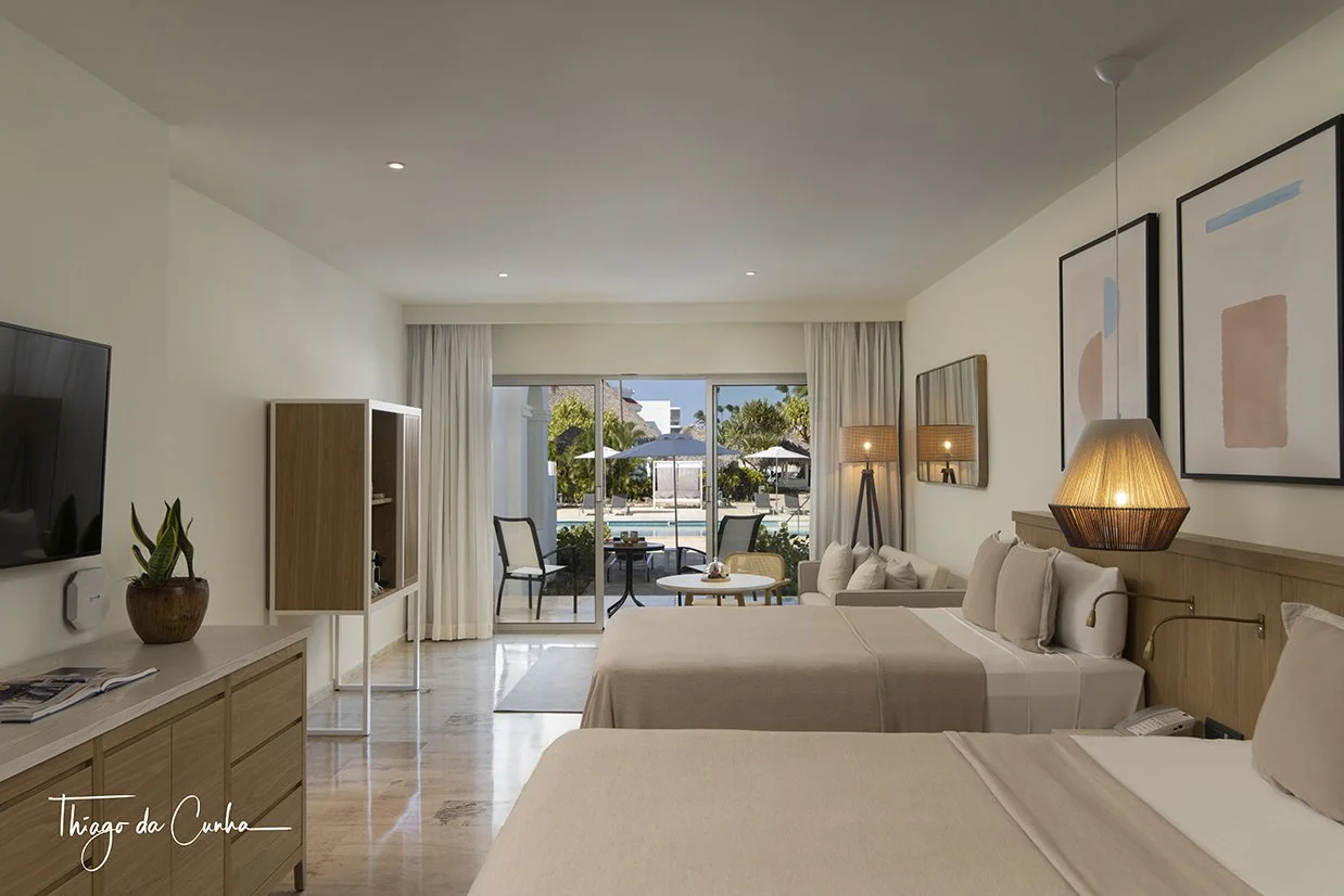 This is the edited image where professional lights were used and blended with ambient light so to make visible the exterior. With this technique you can now see the details in the exterior, the table on the balcony and the pool.