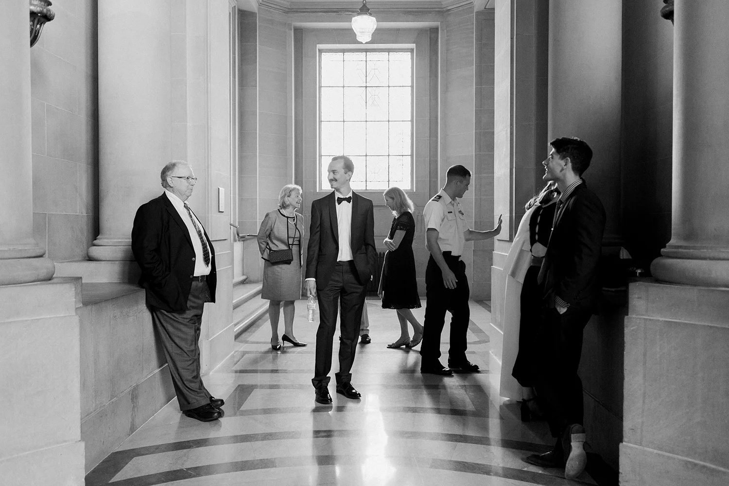 Candid photo of family and groom at wedding in San Francisco City Hall.