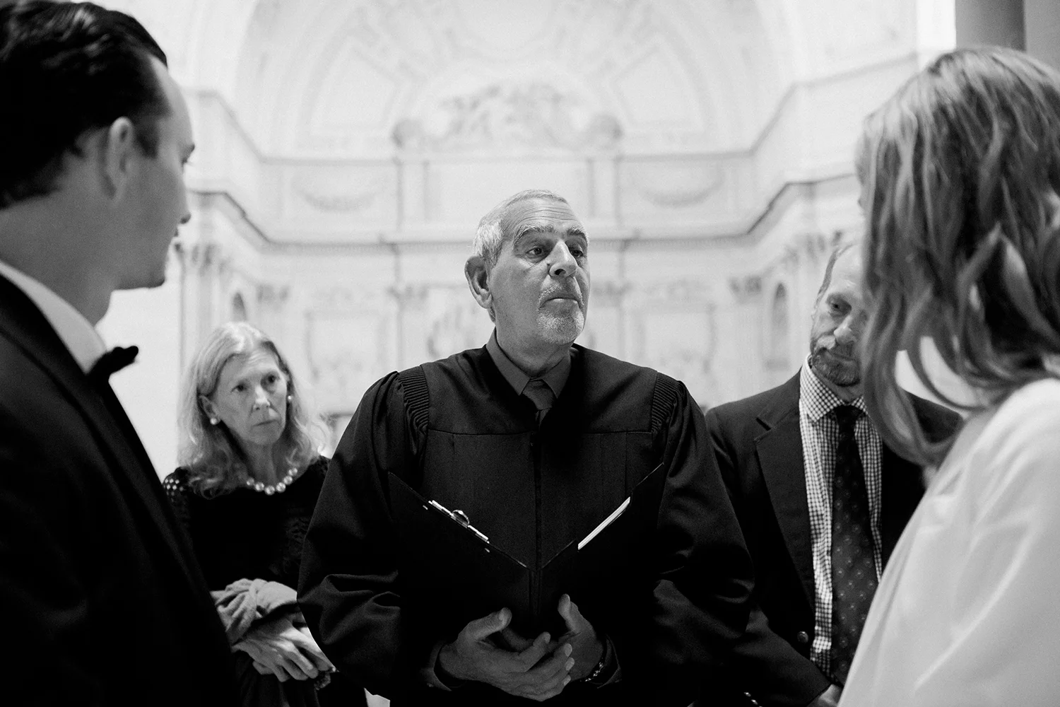 Judge with bride and groom during wedding ceremony in San Francisco City Hall.