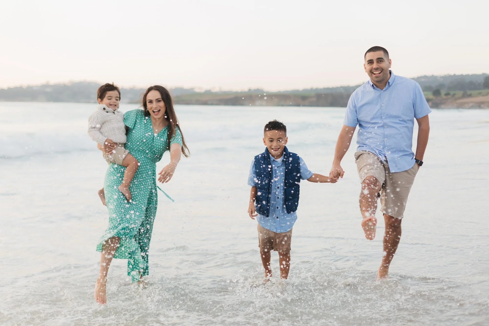 A family playing on the water in Carmel Beach.