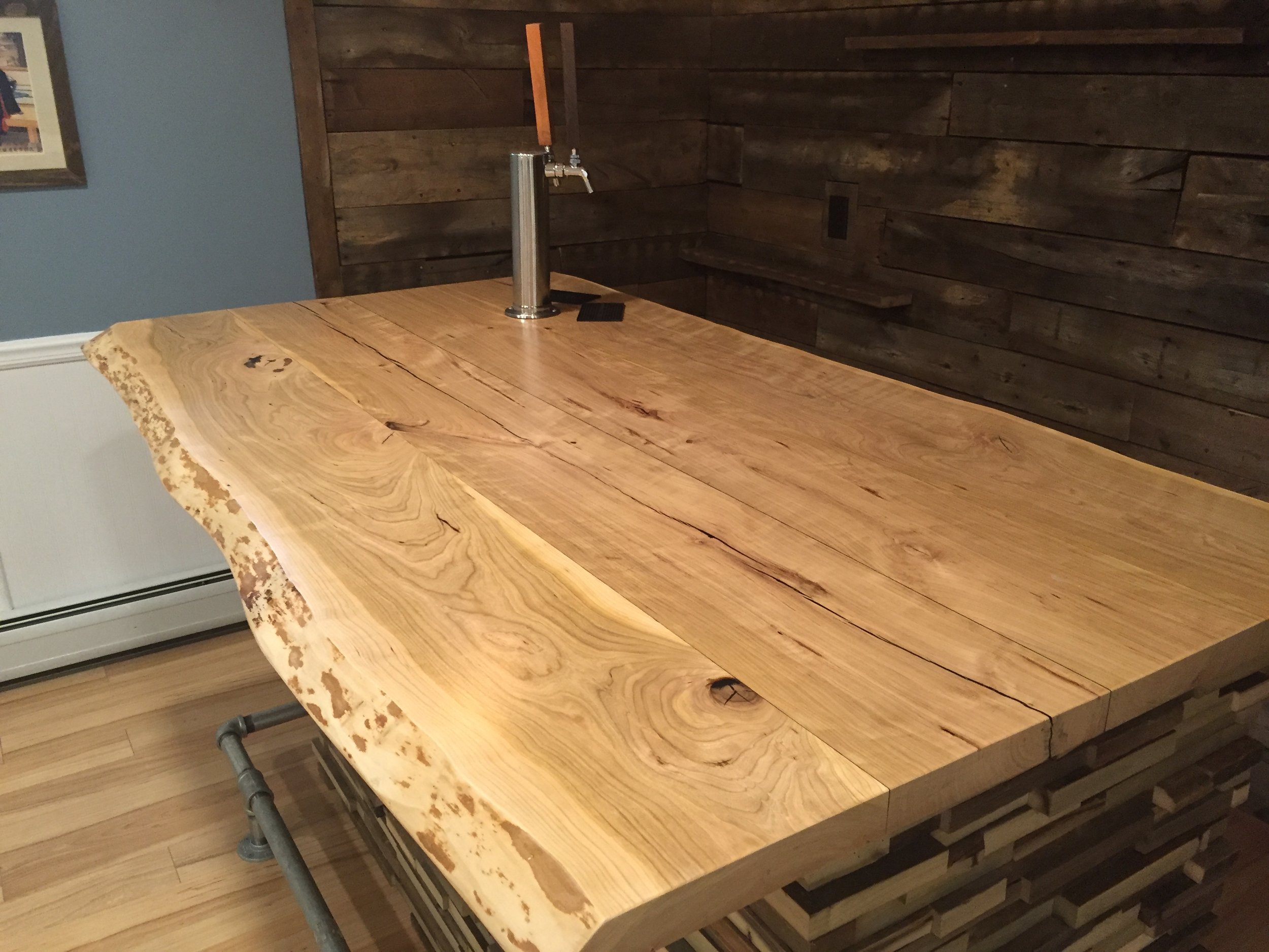  The finished hardwood bar with a built-in beer tap. 